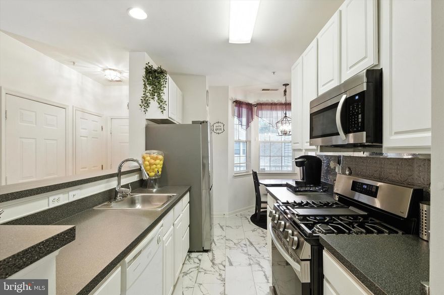 Top-Floor Penthouse Condo with Flexible Living Space in Hollington at Owings Mills New Town

Welcome to this bright and spacious 2-bedroom + den, 2-bath penthouse-level condo offering 1,400 square feet of well-designed, low-maintenance living. Located in the sought-after Hollington section of Owings Mills New Town, this unit features vaulted ceilings, laminate wood flooring, and an open-concept layout perfect for everyday comfort and entertaining.

The den offers flexibility as a third bedroom, home office, or guest space — ideal for today’s lifestyle.

You’ll love the sun-filled living room with a gas fireplace, dedicated dining area, and private balcony with wooded views. The eat-in kitchen features gas cooking, ample cabinetry, and generous counter space. Enjoy the added convenience of an in-unit washer and dryer.

The primary suite includes double closets and a private en-suite bath with a soaking tub and separate shower. A second bedroom and full hall bath complete this well-thought-out layout.

Community amenities include outdoor pools, tennis courts, walking paths, playgrounds, and meticulously maintained common areas. Monthly condo and HOA fees cover lawn care, recreational facilities, and more, ensuring a low-maintenance lifestyle.

Prime location alert: This home is just minutes from the commercial and business districts of Foundry Row, Mill Run Shopping Center, and the Metro Centre at Owings Mills. It's less than two minutes from New Town Elementary and High Schools, close to Stevenson University, and offers easy access to I-695 and I-95, making commuting to Baltimore City or Washington, D.C. smooth and stress-free.