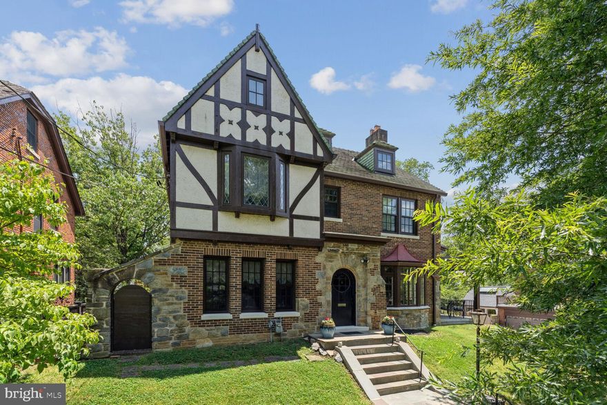 The Tudor Revival style enjoyed its peak of popularity in the late 1920s.  Fine examples are found throughout the United States, but none quite as archetypal as this c. 1929 residence.  All compositional and decorative elements of a high-style example are present here, including handsome brickwork, an enriched frontispiece clad in stone, an imposing front door with bronze hardware, and judicious use of half-timbering.  These features, combined with state-of-the-art appliances and systems make this house unique.  This residence enjoys a prominent location on a large and handsomely landscaped lot. The interior has been meticulously renovated to the highest standards.  Every detail, down to the last stroke of paint, was carefully considered to create a space which honors its history, and yet is comfortable and contemporary.  High quality replacement windows are found throughout, which respect the original fenestrations.  The rooms offer generous proportions with impeccably selected finishes; the entire residence speaks in one voice. On the first floor, there is a large and welcoming foyer, living room with fireplace, equally impressive dining room, a beautifully renovated eat-in kitchen, powder room, and a separate smaller living room which can be used as a den or office.  Access to the porch is found on this floor, which overlooks most of the front and rear gardens.  The second floor offers the principal bedroom with an en suite bathroom and a sensibly designed dressing room equipped with a washer and dryer.  Two other generously sized bedrooms and a hall bathroom clad in marble tile are located on this floor.  The third floor offers an additional two bedrooms and full bathroom, which can function as a private guest suite. The lower level comprises approximately 1,500 square feet and could be used as a home gym or an opportunity for an au pair suite.  An attached two-car garage and surface parking for another four cars supply a level of convenience seldom found at any price.  The property surrounding the house has been as carefully maintained as the residence and offers an opportunity for a swimming pool, a gazebo, or a pergola.