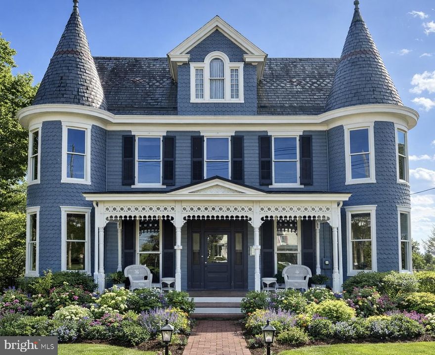 Iconic Victorian “Painted Lady” in the heart of Middletown’s historic district, offering timeless architecture paired with modern comfort. This one-of-a-kind residence showcases striking curb appeal with its signature twin turrets, intricate woodwork, and charming front porch that sets the tone for what awaits inside.

Boasting 5 bedrooms, 4 full baths, and 2 half baths, this home offers exceptional space and flexibility for everyday living and entertaining. Interior features include soaring ceilings, original hardwood floors with detailed inlay, pocket doors, and elegant millwork that highlight the home’s historic craftsmanship. Multiple living and dining areas are anchored by beautiful fireplaces, creating warm, inviting spaces throughout. A bright sunroom adds additional living space, perfect for relaxing year-round.

The home has been thoughtfully updated to meet today’s lifestyle while preserving its character, including a modernized kitchen, a butler’s pantry with a wine fridge, and key system improvements. Large windows fill the home with natural light, enhancing its bright and airy feel.

Step outside to a private backyard oasis featuring a pool, a 6-person hot tub, and outdoor living space, perfect for relaxing or hosting gatherings. A fenced garden space on the south side of the property offers excellent sunlight—ideal for gardening enthusiasts or those seeking a peaceful outdoor retreat. A rare 3-car garage provides ample parking and storage—an exceptional find for a property of this era.

Situated on a generous lot just moments from downtown Middletown, enjoy convenient access to local shops, dining, parks, and commuter routes. A true statement property combining historic charm, functional space, and lifestyle amenities—opportunities like this are rare.