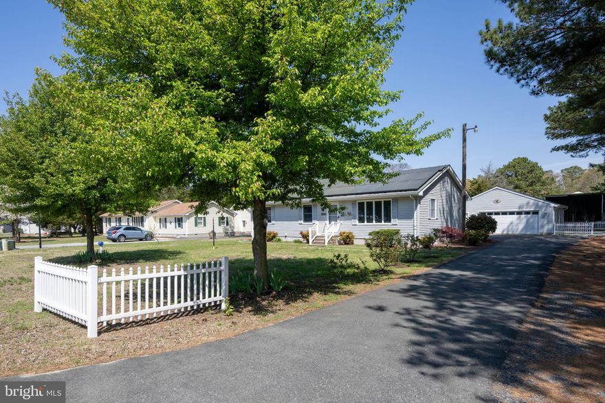 Come check out this charming home in Patty Cannon Estates—offering comfort, privacy, and convenience all in one place! This well-kept single-story ranch sits on just over half an acre and has nearly 1,400 square feet of comfortable living space.  Inside, you’ll find 2 bedrooms and 2 full bathrooms, plus a roomy office that could easily work as a third bedroom if you need it—great for guests, working from home, or extra space.  One of the highlights is the large 900 sq ft detached garage that fits up to 6 cars.  It also has a full bathroom, kitchenette, and a window A/C unit, making it super flexible for storage, hobbies, projects, or even entertaining.  Out back, you’ll find a spacious super clean storage shed, perfect for your riding mower, and you'll love the outdoor living area. The spacious yard gives you plenty of room to garden, play, entertain, or even add a pool or play-gym.  Recent updates include a new hot water heater (2026), septic pump (2025), and updated kitchen appliances and counter-tops (2025).  All of this is tucked into a quiet, established neighborhood that’s still just minutes from shopping, dining, and schools—so you really get the best of both worlds.  Come take a look—you won’t want to miss it!