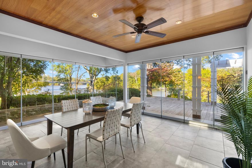 Coveted West Annapolis Waterfront property with deep water floating dock! Recently updated with fresh paint, refinished floors and new carpeting throughout. Experience elegance and grace in this stunning 4 story home that is sure to captivate. The contemporary architecture and voluminous spaces mixed with traditional finishes and floor plan creates a wonderful combination. Expertly designed and built additions include the glass enclosed lanai with elevator and guest room above in 2006, Living room, 2 car garage and bird's nest with balcony completed in 2009, gourmet Kitchen was expanded and beautifully updated in 2015. Upon entry, the soaring foyer is awe-inspiring and the elegant living room, with built-in bar, sets the tone.  With 3 custom bars and multiple gathering areas, this home is perfect for entertaining.  The gourmet kitchen is a chef's dream, featuring a large island and top-of-the-line finishes and breakfast nook, which flows seamlessly into the spacious family room with walls of windows overlooking Weems Creek. The adjacent library/den boasts mahogany built-ins and flooring, gas fireplace and views; a perfect place to curl up with a book. This home offers three ensuite bedrooms for ultimate comfort and privacy. The master bedroom is a sanctuary with a vaulted ceiling, custom built-ins, enormous walk in closet for 2 and the best views in the house.  Wake up every morning and enjoy the activity on the sparkling waters of the creek and the Severn River. The spacious guest room suite with glass breezeway from the main house boasts an elevator directly into the room, creating a truly private oasis for guests and family. This floor also includes an additional bedroom or theater room with adjacent hall bath; providing flexible living options. The fourth floor features a unique bird's nest with elevator access and a wrap-around deck offering panoramic views of Weems Creek and the Severn River. With three elevators throughout the house, accessibility to all four levels is effortless. The exquisite sunroom with folding glass doors epitomizes indoor/outdoor living. Simply open 2 sides of the room to the outdoors and let the party flow onto the sprawling rear deck. The wrap-around IPE deck and multiple level seating areas are ideal for taking in the incredible views from every vista. The lush landscaping and stone stairs lead to the water's edge and the private pier with deep-water floating dock with multiple slips can accommodate a 50ft yacht. Be sure to not miss the stone patio on the way down; ideal for relaxing as the sun sets. This property truly captures the essence of waterfront living by blending luxury and comfort in an unparalleled setting. Welcome Home!