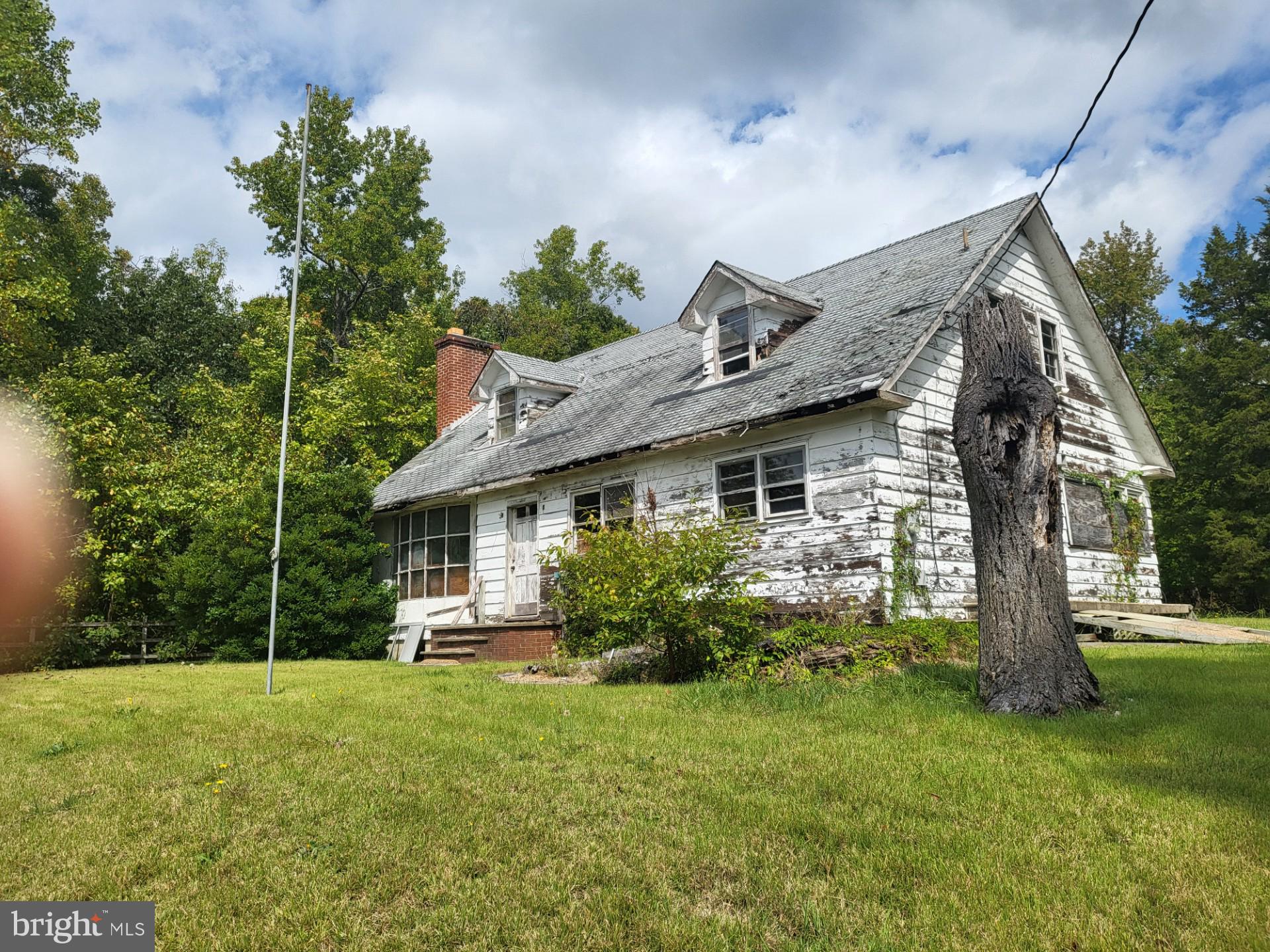 LOWER PRICE! DO NOT ATTEMPT TO ENTER THE HOUSE! Owner is unsure of structural condition. Said home was vandalized and stripped of most everything. It is at best, a Major Rehab. No one is to enter the Property without special permission and having signed a Waiver. If your Client wants to see the interior, it can be arranged after signing Waivers. Anyone entering the home would have had to sign the Waiver prior to entering the home. One can walk around the exterior, but be careful near the house. It is a 1 ACRE lot! After the initial visit, if the Buyer has serious interest, an interior Showing can be scheduled with the Owner through the Listing Agent only. Please do not drive through the backyard. This property is Sold AS-IS and Located in a growing segment of the County and worth checking out...Make an Appointment Today!