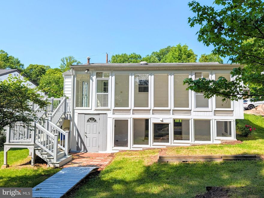 Discover exceptional value and structural integrity in this meticulously remodeled brick residence located in the desirable Berwyn Heights community. The main level showcases elegant, refinished oak hardwood flooring throughout, bathed in natural light from expansive bay windows in both the living room and primary front bedroom. This versatile floor plan features a third bedroom that can easily transition into a formal dining room to suit your lifestyle.

The heart of the home is the remodeled kitchen, which seamlessly opens onto an impressive full-length enclosed sunroom. Positioned directly beneath is a second full sunroom, providing rare dual-level indoor-outdoor living spaces. The upper level further extends to a premium composite deck with stairs leading to a beautifully shaded backyard.

The fully finished lower level offers a spacious family room, a dedicated utility room equipped with a modern washer and dryer, and a private bedroom with required second means of egress for safety and compliance. The full shower bathroom completes level.   Hobbyists and professionals alike will appreciate the substantial 16x20 workshop, fully outfitted with power and gas heat, complemented by an additional storage shed and a private vineyard.

This property is a turn-key investment or residence, currently approved as a rental property with a lead-free certificate in place.