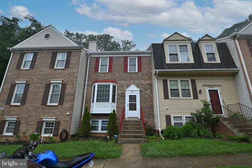 Welcome to 8870 Winding Hollow Way. This spacious brick colonial has much to offer. Enter into the living room where you are greeted by a spacious living room filled with natural light. As you continue into the eat in kitchen area, you'll notice the eat in kitchen offers ample cabinet space, a kitchen island for additional seating, and sliding glass doors which open up to the private deck. The upper level has 3 bedrooms. The primary bedroom with private en-suite has ample closet space and high ceilings. The lower level provides a den, an additional bedroom, full bathroom, and walks out to the fully fenced tree-lined backyard. Schedule you're showing today! Priced to sell