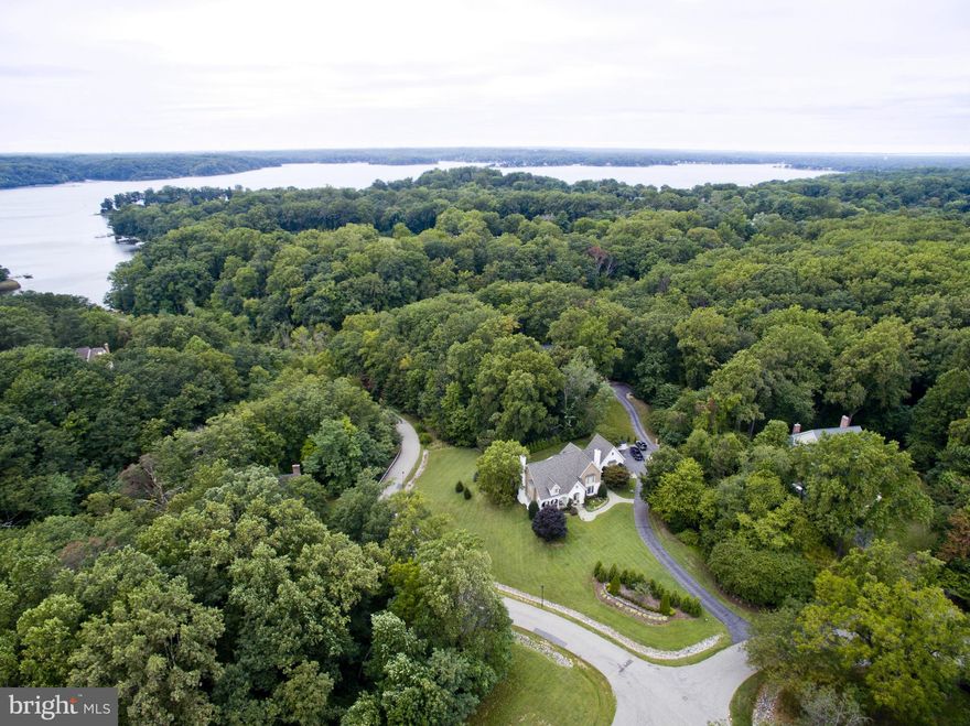 Custom French Country home on 1.16 acres in water privileged Severn View. European farmhouse kitchen; wine cellar; luxurious master suite; au Pair suite; 2 indoor fireplaces; large outdoor entertaining space with kitchen, pergola, covered terrace, and deck; and 2-car garage. Walk to private neighborhood marina with deeded 50 ft deep water boat slip. Severna Park schools.