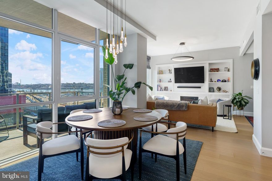 Welcome to waterfront, elevated city living at The Liberty Harbor East, one of the most sought-after boutique residences in Harbor East, where modern design meets vibrant waterfront energy.
This extraordinary fifth-floor residence, built in 2019, offers 1,163 square feet of refined living space with one bedroom, one full bath, and a versatile den. 

Recently enhanced with thoughtful, high-end upgrades, the home now features fresh designer paint, new modern lighting with Lutron smart lighting system, and custom built-ins that elevate both style and functionality. The layout has been reimagined with the removal of the wall between the den and living area, creating an even more open and expansive living space, perfect for today’s lifestyle. 

From the moment you enter, you’re greeted by soaring 10-foot ceilings and dramatic floor-to-ceiling windows that flood the home with natural light while showcasing breathtaking southwest views of downtown Baltimore. New custom blinds, fully integrated with Alexa for smart home convenience, add both luxury and ease of living.

The living and dining areas flow seamlessly into a chef’s kitchen featuring sleek Italkraft cabinetry, premium Thermador appliances, and a striking Calacatta marble waterfall island, ideal for entertaining. Tucked privately beyond the foyer, the spacious primary suite has been elevated with a stunning custom wood-paneled accent wall and offers access to a private balcony overlooking the iconic Inner Harbor. 

The spa-inspired bath is a true retreat, featuring Carrara marble, Kallista and Kohler fixtures, an expansive walk-in shower, and a custom dual vanity, while the oversized walk-in closet provides abundant storage.  Additional upgrades include a whole-house water filtration system and a new hot water heater, ensuring comfort and peace of mind. 

Residents of The Liberty enjoy a full suite of resort-style amenities, including a rooftop infinity pool with cabanas, a state-of-the-art fitness center and yoga studio, pet park with agility equipment, and beautifully designed social spaces such as a clubroom with indoor/outdoor bar, private dining rooms, and a concierge lounge. Additional conveniences include a secure package room, ButterflyMX smart intercom system, conference rooms, EV charging stations, and garage parking availability. 

Adding to the unmatched lifestyle, The Liberty offers direct access to a flagship Whole Foods Market, making everyday living effortless. Just steps away, Harbor East is home to some of Baltimore’s finest dining, boutique shopping, and scenic waterfront promenades, placing the very best of the city right outside your door. This is more than a home, it’s a lifestyle defined by luxury, convenience, and sophistication in one of Baltimore’s premier waterfront communities.