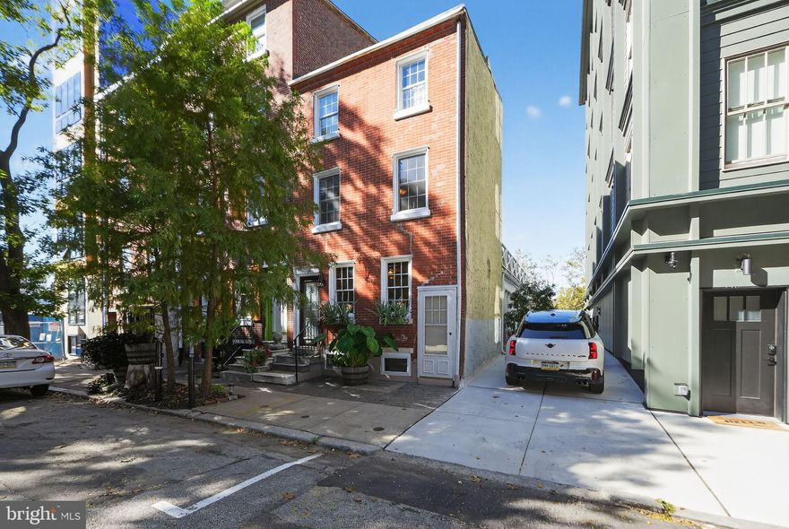 Timeless Historic Charm Meets Modern Comfort in the Heart of Old City
Nestled on a quiet, tree-lined street, 254 N Lawrence Street is a beautifully reimagined red brick residence that blends historic character with modern sophistication. Built in 1890, this home offers 4 bedrooms, 2.5 baths, 1,847 SF and private outdoor spaces on every level.
Inside, the inviting living room features a gas fireplace with a classic mantel, original wide-plank hardwood floors, exposed beams, and interior wood shutters. Beyond the trinity-style staircase, the dining area transitions seamlessly into a modern kitchen with granite countertops, custom cabinetry, and stainless steel appliances.
At the rear of the home, a sunlit den surrounded by glass doors opens to a private back and side patio—ideal for grilling, entertaining, and effortless indoor-outdoor living. A powder room completes this level.
The second floor includes two spacious bedrooms, a full bath with laundry, and a private deck. The third floor, with its vaulted ceilings, offers two additional bedrooms, a large full bath with a clawfoot soaking tub, and another deck with skyline views. Original hardwood floors continue throughout the upper levels.
A full basement provides ample storage and updated utilities.   Additional features include new windows and interior ductwork allowing for Central Air to be installed. 
Experience the perfect blend of historic craftsmanship, modern updates, and urban tranquility in one of Philadelphia’s most desirable neighborhoods.
Located steps from Radicchio Café, Kisso Sushi Bar, Independence Mall, Cherry Street Pier, and Spruce Street Harbor Park, with easy access to I-95, I-676, Benjamin Franklin Bridge and public transit.
254 N Lawrence Street — where Old City charm meets contemporary comfort. Schedule your private showing today.