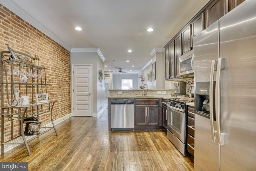 Pride of ownership abounds in this well maintained 2-3 bedroom  3 full bath recently renovated home.  Prime location close to the Park and all the Arts districts wonderfully unique shops and restaurants.
Features include original hardwoods throughout 1st and second level,  Kitchen with breakfast bar, granite, and stainless appliances, main level laundry, easy access PARKING pad.  Upper level boasts good size bedrooms with ample closet space and  2 full baths, along with access to a well maintained roof deck.  The fully finished lower level is great flex space.  It's currently set up as a guest room and family room with a full bath.  Save approximately $3000.00 or more with remaining tax credit.