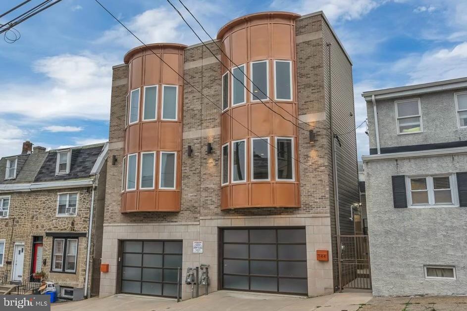 Just steps from the energy of Main Street, this beautifully crafted 3-bedroom, 3.5-bath home blends modern design with everyday comfort in one of Philadelphia’s most desirable neighborhoods. With thoughtful updates, quality finishes, and an unbeatable location, it offers a rare chance to enjoy low-maintenance living in the heart of the city.
A limestone façade and striking two-story bay window give the home standout curb appeal. Inside, natural light pours through oversized windows and tall ceilings, while a freshly repainted interior enhances the bright, open feel. The layout flows effortlessly, creating spaces that feel both elegant and livable.
Choose between a private side entrance or direct access through your garage—an especially rare convenience in this area. The lower level is fully finished and offers flexible use: it’s currently a bedroom with an en-suite bath, but could easily function as a guest suite, home office, media room, or gym. Sliding glass doors lead to a fenced backyard, ideal for relaxing or entertaining.
Upstairs, the main living area connects seamlessly with the kitchen, featuring granite countertops, 42-inch cabinetry, and stainless steel appliances. A sliding door off the kitchen overlooks the backyard and fills the space with natural light. A well-placed powder room rounds out this level.
The top floor includes two spacious bedrooms, each with its own en-suite bathroom. The primary suite features a large walk-in closet and a spa-inspired bath, while the second bedroom includes a soaking tub and a sliding glass door with peaceful views of the yard. A full-size washer and dryer are conveniently located on this floor as well.
For outdoor living, enjoy not one but two rooftop decks—perfect for morning coffee, evening drinks, or simply soaking in the city skyline. The private backyard adds another quiet, versatile space to enjoy year-round.
Additional highlights include two years remaining on the tax abatement and recent maintenance updates, including the roof—completed just two years ago—for added peace of mind.
Tucked in a vibrant community just blocks from boutiques, restaurants, the train station, and green spaces like the Schuylkill River Trail and Fairmount Park, this home truly offers the best of city living—with comfort, style, and convenience at every turn.
Schedule your private tour today and come see what makes this home feel so special.