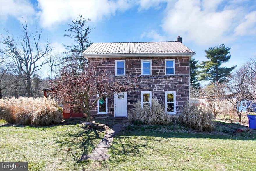 Classic 1800's Stone Home. Deep window wells & some original wood floors. The front door has a leaded glass window & steps into what we're calling the Living Room but could have multiple uses. The adjoining Den was previously used as a bedroom or could be the living room. The Kitchen has an island & is very spacious with more built-ins & large Dining Area. Kitchen also offers access to a closed in porch. There is a half bath w/Laundry that rounds out the first floor. Stairlift installed to the second level (seller will have it removed if buyer requests). The 2nd floor offers a Full Bath & 3 Bedrooms, (one Bedroom does not have a door or closet & is a pass through for second Bedroom & has attic access).  Metal roof over main house. Outbuilding with electric. Nice level 3/4-acre lot that has lots of perennials & some fruit trees.  If you appreciate older homes & are handy this could be the right home for you!!