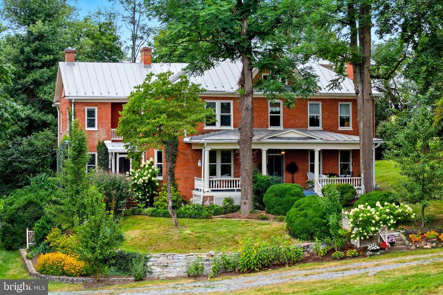 APPLE PIE RIDGE...A Legacy Unbroken: Lost Stream Farm, a 7-Generation Family Heirloom

Welcome to Lost Stream Farm, a place where history isn't just a date in a book—it's alive in the brick and stone of every wall. Dating back to the late 1700s, this Quaker-built dwelling has been a cherished family home for an astonishing seven generations. For the very first time in 235 years, it's now ready for new owners to become its next stewards.
Nestled on just over 11 acres at the top of Apple Pie Ridge—the heart of Winchester's famous apple country—this property is a testament to a family's deep connection to the land. This is a home built from the earth it stands on; the original brick and stone were meticulously sourced from the property itself, a physical manifestation of a family's enduring legacy. This family was among the earliest orchardists in Frederick County, a legacy that helped earn Winchester its "Apple Capital of the World" title. You can feel this profound history in the gentle landscape, from the apple orchards that once flourished to the very ground that was cared for over centuries. The original bell, once rung to call in the workers from the apple orchards, still stands on the property as a tribute to this rich past.
Stepping inside this 4-story brick manor house is like stepping into a living story. The home was thoughtfully expanded in the early 1900s, doubling its size while seamlessly preserving its historical integrity. For over 50 years, John and Katie Anderson lovingly cared for this home, becoming its stewards and meticulously undertaking major renovations that honored its past while providing modern comfort. A new standing seam metal roof (2017) was installed, and the home features six fireplaces. Major updates include Central Heat and Air Conditioning (2022), a new bathroom with a walk-in, glass-walled shower, and a gorgeous kitchen with a built-in stovetop in the old fireplace and beautiful handmade cabinets.
Outside, the property is a true sanctuary, located just 5 minutes from Winchester Medical Center and 10 minutes from downtown Winchester. A beautifully renovated 2-car garage (2025) was seamlessly integrated with the property’s original spring house, a historic structure that once supplied water to the home. The active spring overflow feeds a stream that runs along the property and is a wildlife sanctuary for deer, turkey, birds, and other animals. There is a separate, small spring-fed pond on the property which has fish and turtles. The back patio provides a peaceful escape, where a serene koi pond flourishes with lush vegetation and koi fish, surrounded by vibrant flowers that bloom throughout the seasons. A separate garden shed, an equipment shed, and a charming 2-story bank barn offer endless possibilities. The land itself is a rare find, composed of two parcels, offering a unique opportunity to build or protect the surrounding land.
This is more than a home; it’s an invitation to own a serene, private slice of history—a place for long walks, gardens, or horses, and sipping a glass of tea on the expansive front porch swing. A property that has never been sold and has waited nearly 235 years to find its next guardian.
NOTE:  This listing includes 2 parcels of land totaling 11.36 acres.  Public records and other sources  only show the valuation for the property as the manor home on 6.3 acres.  An additional 5.06 acre parcel is included (with permit approved for 3-bedroom septic).
Schedule your private tour today. PLEASE, NO DRIVE-BYS as the driveway has no turnaround without going directly to the residence.