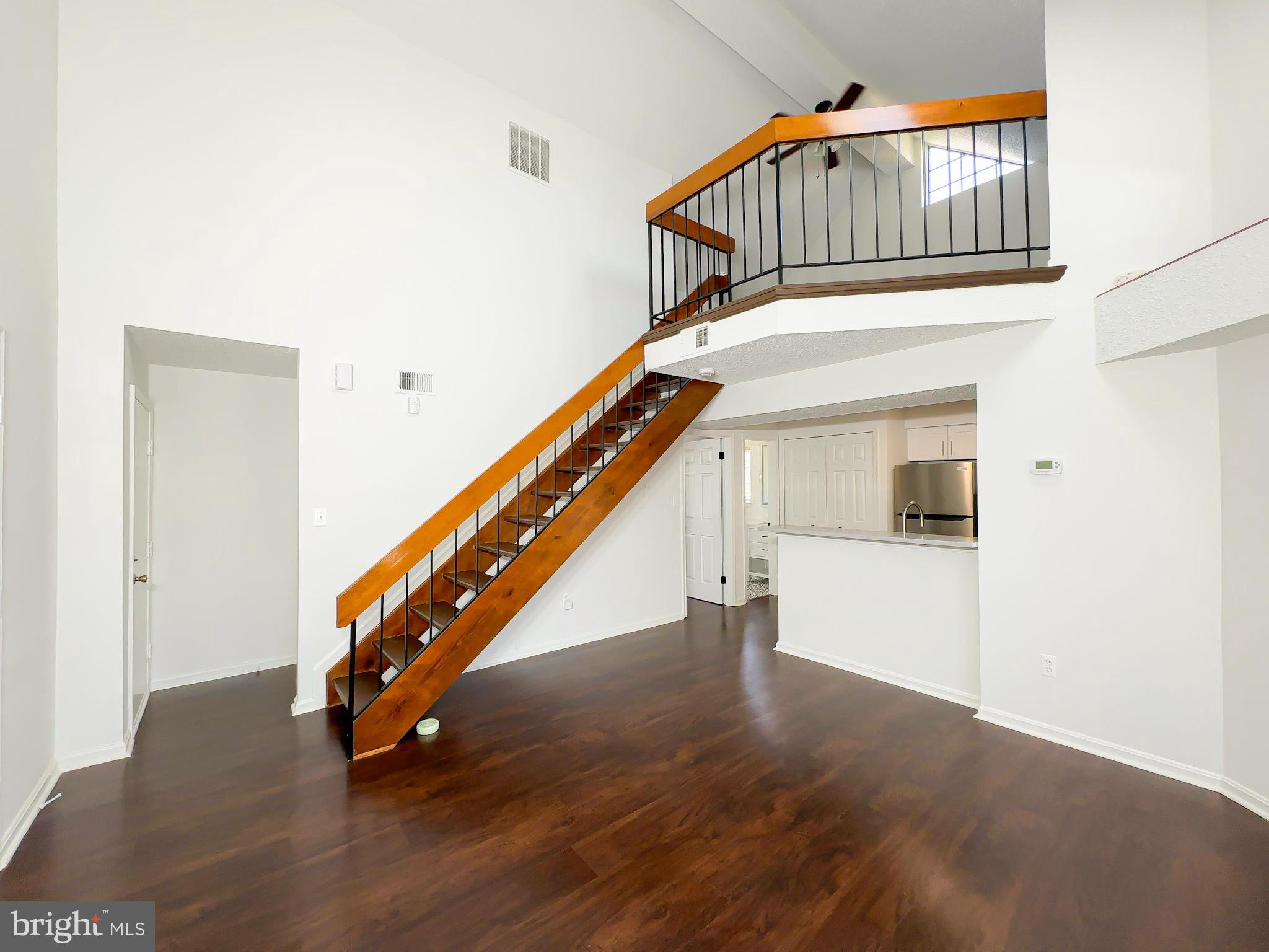 VA FINANCING and / or CASH ONLY ARE REQUIRED! AFFORDABLY PRICED CONDO PLUS SELLER WILL PAY 12 MONTHS OF MONTHLY & SPECIAL ASSESSMENTS OR USE TOWARDS CLOSING COSTS WITH FULL PRICE OFFER! Community is NOT FHA approved! Step into this renovated one-bedroom condo with a loft, where modern style meets thoughtful functionality. As you enter through the front or rear door, you’ll be welcomed by the natural light pouring through skylight and windows, beautifully accentuating the neutral tones of the walls, stairs, and the carefully crafted newly installed flooring that enhances the home’s elegance. The loft, with its commanding view of the living space below, offers a touch of sophistication, and features a cozy fireplace for wintry evenings, a remote-controlled ceiling fan for added convenience, as well as newly installed insulation in the attic. The brand-new gourmet kitchen is a true centerpiece, boasting quartz countertops, sleek stainless-steel appliances, soft-close cabinetry, and a cleverly concealed laundry area just within reach. The bathroom elevates your daily routine with motion-sensor lighting, chic art deco flooring, and a smart-touch mirror providing adjustable lighting to suit your mood.
With the bedroom and bathroom thoughtfully located on the main level, this home ensures ease and comfort in single-level living. Whether you’re relaxing, entertaining, or simply enjoying the charm of your surroundings, this unique space is sold As-Is.