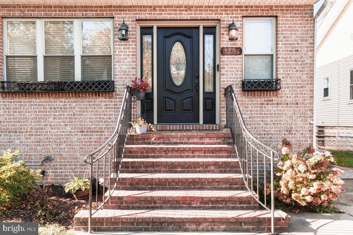Modern Elegance Meets Classic Charm in Hamilton Heights!  Welcome to this beautifully restored Colonial style gem, nestled in the heart of Hamilton Heights, one of Baltimore’s most beloved and established neighborhoods. Originally built in 1926, this nearly 2,000 sq. ft. residence has been thoughtfully renovated from top to bottom, seamlessly blending timeless architecture with the comforts of modern living.  Step inside and experience an inviting open floor concept design, where the living and dining areas flow effortlessly together, creating the true heart of the home. Perfect for entertaining or enjoying peaceful evenings at home. This home features rich hardwood floors throughout, a beautiful fireplace on the main level and skylights that bathe the rooms in warm, natural light. The gourmet kitchen offers both style and functionality, with a large center island, generous table space, and classic Wellborn cabinetry. Whether you’re preparing meals or sharing morning coffee, this kitchen inspires connection, creativity, and comfort.  Step outside to your private backyard oasis, ideal for family gatherings, cookouts, or quiet relaxation. The spacious deck overlooks a fenced yard where children and pets can play freely in a perfect extension of your living space.  Upstairs, retreat to the luxurious primary suite, complete with its own fireplace, private balcony, and a spa inspired bathroom featuring a jetted tub, separate step in shower and double sinks. Get dressed in the large walk in closet with a built in shoe station. Every detail has been designed for both elegance and ease.  The fully finished basement expands your living possibilities, offering flexible space for a home office, gym, entertainment lounge, or guest suite. A full bath with walk in shower and neatly integrated laundry area add convenience, while a side walkout provides easy access.  Additional highlights include plenty of storage space, off street parking in a private driveway, and a monitored security system for added peace of mind.  Set on a manageable 0.12 acre lot, this home perfectly balances comfort, character, and convenience, all within minutes of local shops, restaurants, parks, and major routes including I-95, I-895, and I-695.  This is more than a house, it’s a sanctuary where classic beauty meets modern living.  Come see for yourself why this Hamilton Heights treasure is truly one of a kind. Schedule your visit today and make it yours.