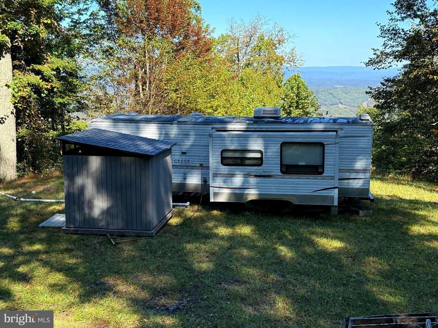 41 ACRES| UTILITIES INSTALLED | MOUNTAIN VIEWS =============================
Discover 41 acres of wooded mountain land offering privacy, seclusion, and endless outdoor opportunities. This property is already set up with electric service and septic system in place, saving you time and expense. A camper conveys as-is, along with an 8’x8’ storage building, making it easy to enjoy right away.

The land features a mix of sloping but accessible terrain, maintained log roads throughout, and breathtaking mountain views that can be further opened with selective clearing. A gated entrance provides security and privacy. Hunters will love the abundant wildlife, while outdoor enthusiasts can explore trails, ride ATVs, or simply relax in the peace and quiet of the mountains.

For those looking to expand, an adjoining 40-acre parcel is available for purchase with the purchase of this parcel , offering the potential for over 80 acres of pristine land.

Whether you’re searching for a hunting retreat, a weekend getaway, or a future build site with utilities already installed, this property is a true find.