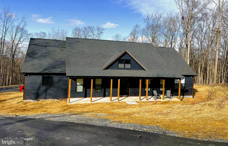 Follow your private  driveway to this to be built modern farmhouse, located in the prestigious Waterside Reserve community situated on a stunning 9.5 acres with a small pond .  This community has access to the scenic Shenandoah River and offers a serene retreat just 5 minutes from downtown historic Charles Town. Only 2 minutes from Rt. 115, a major commuting route to Northern Virginia and Suburban Maryland, this estate is the perfect blend of rural tranquility and convenient access.
Step inside, where elegance and thoughtful design greet you at every turn. The open-concept living area seamlessly connects the upgraded kitchen, dining space, and family room—creating a warm and inviting atmosphere for both relaxed family time and vibrant entertaining. The formal dining room and private office are situated off the main foyer, providing refined spaces for hosting and productivity.
The chef's kitchen is a dream come true, boasting stainless steel appliances, ample storage in the cabinetry, walk in pantry and butler’s pantry perfect for entertaining in style.
This home’s design is tailored for multigenerational living with an unfinished lower level that could serve as an independent living space or use the finished room over the garage as unparalleled comfort and autonomy for extended family or guests.
The lavish primary suite is truly massive, featuring tray ceilings and a spa-like en-suite bathroom —a luxurious haven designed for ultimate relaxation. The home's split floor plan layout provides additional privacy, with each bedroom offering its own en-suite bathroom, ensuring every occupant enjoys a personal retreat.
Unwind on the gracious southern front porch or the cozy covered rear porch, where you can enjoy your morning coffee while soaking in the tranquil natural surroundings. Whether you're looking for peace and privacy or a place to gather and entertain, this outdoor space offers it all.
The side-entry three-car garage provides ample space for vehicles and storage, perfectly complementing the thoughtful layout of the home. The builder has thought of everything!  
Located in an upscale community with Shenandoah River access, this property offers the best of both worlds—quiet country living within close proximity to essential amenities and major commuting routes. It’s truly a one-of-a-kind opportunity to live in luxury while embracing nature and convenience. 
Picture is of a similar construction and is to be built.