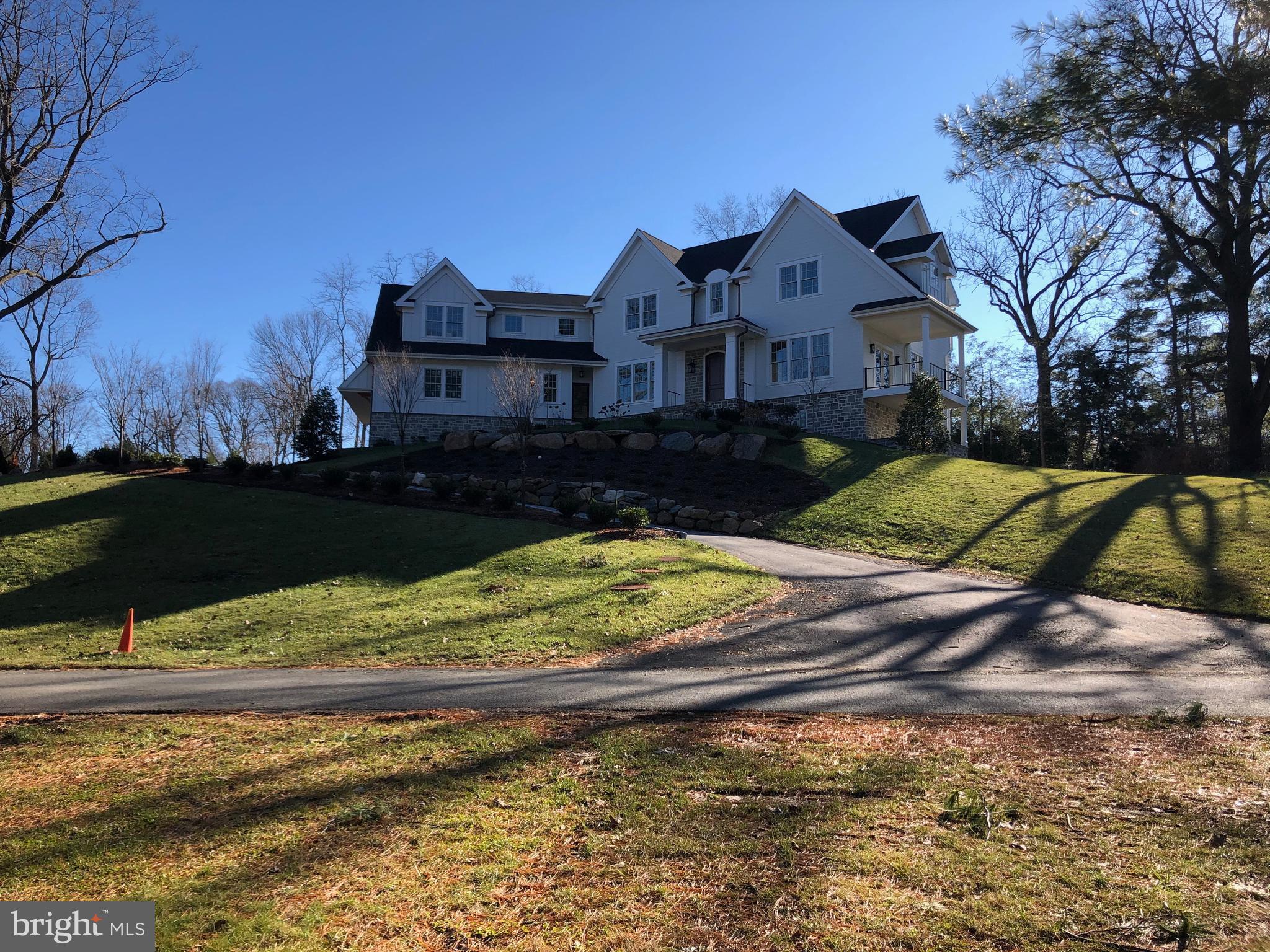 Take a long drive down the private lane off Newtown Road to #753 and you'll be overlooking the rolling fields of Androssan. The owners on the private lane have snow removal including driveways of the 5 residents on the lane ! What a nice bonus ! This New construction home has incredible views from the side deck but also private entertaining from the rear covered blue flagstone patio with its cozy wood burning fireplace and built in television. The home has a very beautiful entrance with custom wainscotting and embraces the center hall staircase with adjacent living and dining rooms. An interior office with large pocket doors and custom wood built in desk area allows for private work to be done or opening it to have an overflow from the living room. A very useful custom wine room with black iron door and display window accents those living spaces as well as a large cloak room and formal powder room. In the rear of the home you have the expansive family area with a wall of windows allowing much natural light and a custom treatment ceiling. The room is open to the sitting area with a wood burning fireplace (gas ready if need be) that has a modern flair concrete surround. This reading area is adjacent to a custom chef's kitchen complete with wolf range, subzero, ice maker and custom designed cabinetry of solid wood with a glass door leading into an expansive scullery for plenty of storage capability for the master chef in you! A rear powder room leads to a cubby room which can be customized for a second laundry, storage room, athletic closet or it can even include a dog wash if so desired! The 3 car garage can accommodate lifts if you are a car collector. The second floor houses the master suite with tray ceiling, reading lights, and a linear gas fireplace in a white washed brick surround. On the way to the master bathroom there are individual his and her custom fitted closets and the master bathroom has radiant floor heating complete with his and her vanities with towers, double bowl sinks, a makeup station built in, an over sized shower, soaking tub and private water closet. From the master, the hallway leads to an open staircase to the third floor which can be finished out or left as storage as well as 4 additional bedrooms all en suite ! Each bedroom has their own custom tiled baths and individual large walk in closets. The custom laundry room is very spacious with a patterned tile floor, sun lit window with another large out of season walk in closet so storage is ample ! The daylight walk out basement is unfinished so you can make it your own . Available now ! **Special Note - part of the Private Lane Association includes snow plow of Driveways to Garage door !