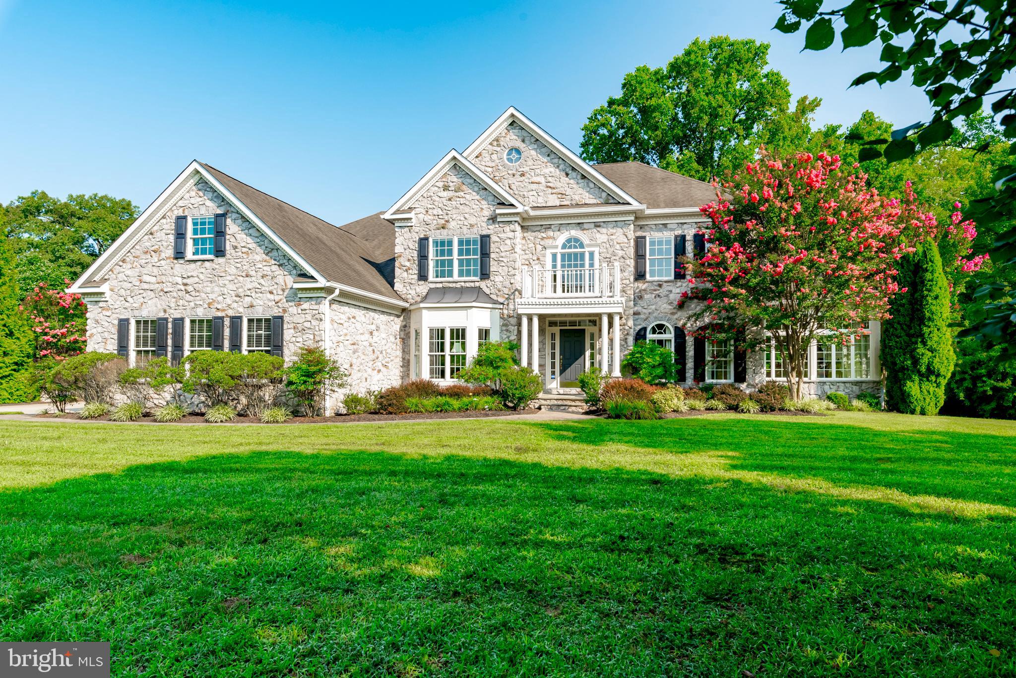 This private Oasis in Crownsville is perfectly secluded while close to everything! No need to join a club, this home will be your sanctuary. With over an acre of flat lawns and a stunning in-ground Pebble-Tec gunite swimming pool, imagine gathering with your family and friends for all of life's special occasions. This gorgeous home was skillfully constructed, meticulously maintained and is turn-key ready for your many years of memories to come! Three beautiful floors of open space include four bedrooms, a gourmet kitchen, sunny breakfast room, a study, a sunroom, a projection room and more! From the moment you pull up you will be captivated by the elegance of the stone exterior. Lush plantings envelope the property adding just the right amount of privacy and a pop of color all year long. The two story entry gives a grand feeling while the rooms are cozy and inviting. Professionally decorated with neutral paint, hard wood floors and fine mill work throughout, this home exudes timeless elegance. The chef's kitchen is a showpiece of the home with custom maple cabinetry, 8 burner stove, double wall ovens an oversized island and a sunny breakfast room that leads to the composite deck. The owner's suite is a true retreat complete with a wet bar perfect for that first cup of coffee or last glass of wine in the evening. The spa bath leads to an enormous closet which is hard to come by. Each of the other bedrooms are spacious and light filled with large closets and ensuite baths. The lower level feels like a private club with a recreation room, game room, exercise room, theatre room, full bath and kitchen (and plenty of storage!) The Paddocks is a hidden enclave of luxury homes close to commuter routes to both Washington and Baltimore and a quick fifteen minute ride to downtown Historic Annapolis. You are surrounded by opportunities to enjoy golfing, shopping, dining, horse-back riding, boating and more! Check out our virtual walk through tour and don't miss the OPEN HOUSE SATURDAY 8/24/24 12-2 PM