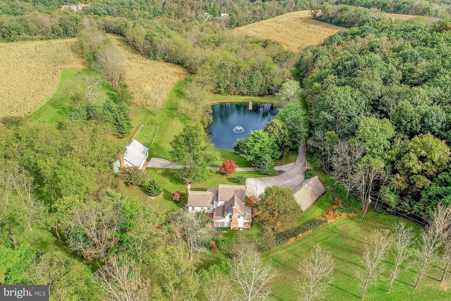 SECLUDED AND MAGNIFICENT ESTATE located in Southern York County within 5 miles of the Maryland state line. This Log Home dates back to 1895 and is situated on 51.27 acres and was completely renovated and restored in the early 1990's.  The 28' x 42' Bank Barn was built in 2002 and features an insulated upper level and an open lower level with a concrete floor and a small kennel with an outside run.  Additional amenities include an oversized 3-car detached garage and workshop,   landscaping and hardscape including a brick patio and water fountain. There is a large pond complete with a dock and an aerator. Refer to the additional features addendum included in the associated docs with a complete list of features and details regarding this one-of-a-kind property and view all of the photos including the aerial views of the estate.