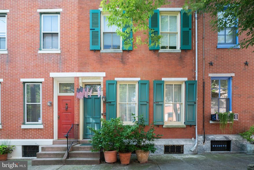 5 bedroom + den, 4.5 bath home with attached parking on quiet tree-lined street in the Spring Garden Historic District. Through entry foyer to spacious living room with high ceilings, crown moldings and large windows. Curved stair with original banister and door to half bath with skylight. Dining room with wood floors and chair rail lead to sunny, South-facing kitchen with large center island, stainless steel range and hood, double sinks, abundant storage, pantry and space for a large eat-in table. Second floor family room/home office with built-in bookcases, adjacent sun room with wood floors and back stair. 2 bedrooms with jack-and-jill bathroom in the front of the second floor. Third floor rear is the sunny primary bedroom suite with many windows, skylight, vaulted ceiling, wood floors and bay open to South-facing deck with retractable shade awning and pulley for bringing pots and supplies to the deck. Spacious bathroom with double sink vanity and stall shower. 2 additional bedrooms and jack-and-jill bath with tub/shower also on this level. Full basement with laundry room, terrific storage and potential for home gym, media/family room or space for hobbies. Door from basement to back parking space on Clay Street which can be entered from 21st and 22nd streets. Amazing location, blocks from Whole Foods, Target, Fairmount Ave, Kelly and MLK drives, restaurants, shops, museums, public transportation and all Center City has to offer.