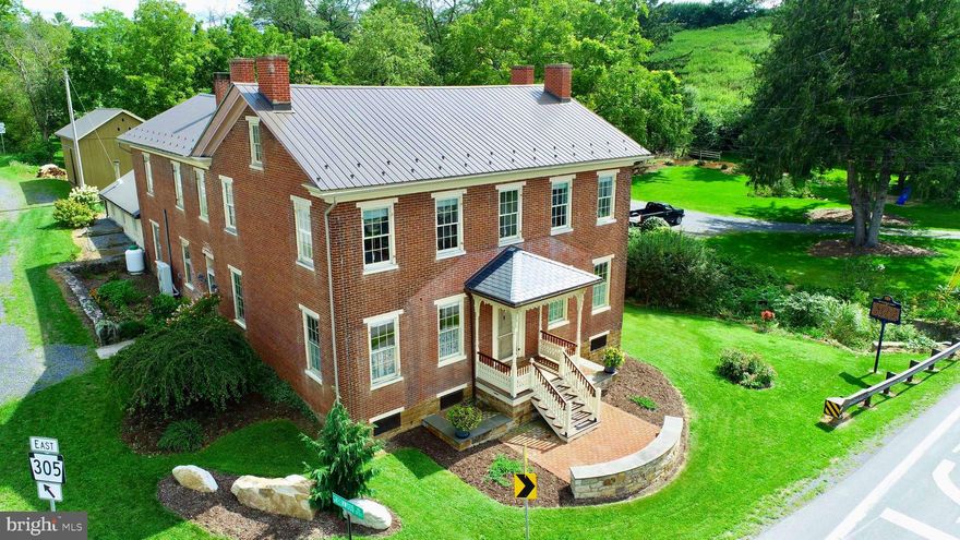 McBurney Manor – Historic Elegance with Modern Comforts

Step into the timeless charm of McBurney Manor built in1842 , a beautifully preserved historic home centrally located between State College, Belleville, and Huntingdon. Just a short drive to Greenwood Furnace State Park, Whipples Dam State Park and Raystown Lake, this unique property offers the perfect blend of historic character and modern convenience.

Boasting four finished bedrooms and two full baths, the home features a well-designed main floor, complete with a spacious kitchen (w/propane fireplace), family room (w/wood burning fireplace), sitting room,(w/wood burning fireplace) laundry room(w/custom cabinetry), and a dedicated woodworking shop. The second floor includes an 4 bedrooms, office space and an unfinished room just waiting for you to give it your personal touches, offering flexibility for additional living or creative space.
Recent updates include a new metal roof, modern HVAC systems, and an outdoor wood-fired hot water furnace, ensuring efficiency and comfort year-round. The home is serviced by an on-site septic system and a spring-fed water supply, providing self-sufficient living.

Historic details abound, including a curved staircase, original woodwork, doors, and trim, a restored lower-level work kitchen featuring a massive stone fireplace.  The second-story porch offers a serene retreat, perfect for star gazing, relaxing and listening to the stream.  There is even plenty of onsite parking accessed over a charming, well- built  foot bridge.

The estate also includes a restored historic exterior bakehouse and a carriage house, adding to its character and potential. Whether you're seeking a private residence, a historic retreat, or a distinctive investment opportunity, McBurney Mansion is a rare find that must be seen to be fully appreciated.