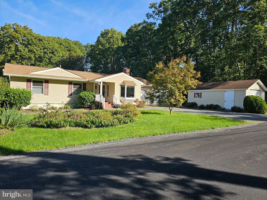 Drum Point Opportunity! Whether you are looking to upsize, downsize, or just want the flexibility of an ADU, this home has it all! This home has been lovingly maintained with many improvements. When entering, you’ll appreciate the large bay window, the gas fireplace, and the spacious open floorplan. The entry-level owner’s suite is large, with an oversized closet and ensuite. An addition in 2013 added a large sunroom across the back of the home overlooking the inground pool. This light and bright space lets the breezes from Mill Creek across the street flow through the windows and offers multiple uses - sitting area to enjoy coffee, office, music room, game room, play room, dining room... the options are endless. Downstairs, you’ll find a family room and a large bedroom featuring an oversized walk-in closet with built-in organizers. There is also an updated bathroom with a step-in shower. Out back, the fenced pool area features a covered patio for enjoying summertime fun by the pool.  In 2024, a pool cover pump and a new Polaris were added, and the pool pump was new in 2023. The yard is full of blooming plants throughout the year and includes, among its many varieties, a huge fig tree. There are three garages, but one is used primarily as a shed. One garage attached to the home has a workshop area. The large detached one-car garage is oversized and has ample storage on the main level as well as additional storage space above. And some of the major homeowner woes have been addressed: new roof 2019, new septic 2005, and new HVAC in 2020.   Schedule your visit today!