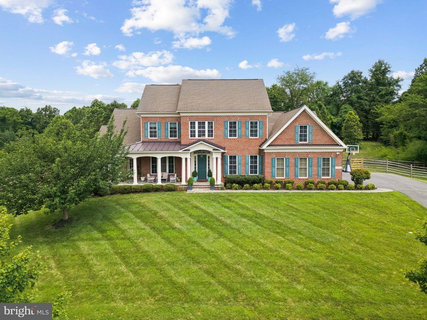 Welcome to an extraordinary opportunity to own a timeless residence where luxury and lifestyle blend effortlessly on a manicured .78-acre lot. Perfectly positioned in a serene, tree-lined enclave, this elegant home offers dual primary suites, refined interiors, and an entertainer’s layout—crafted for the modern lifestyle with an eye for timeless comfort. Step through the welcoming front porch into a sun-drenched main level adorned with rich hardwood floors, custom millwork, and an intuitive floorplan designed for both grand entertaining and everyday living. A main-level primary suite becomes your private sanctuary, complete with dual walk-in closets, a spa-inspired bath with soaking tub, walk-in shower, private water closet, and direct access to the front porch—perfect for sunrise moments. A private study/playroom, formal dining room, and open-concept family room flow seamlessly into a chef’s kitchen featuring a walk-in pantry, large island, and breakfast nook that spills out onto a stone patio—ideal for weekend brunches or evening soirees under the stars. The spacious mudroom with custom closet, laundry room, and 3-car garage round out this level with functional elegance. Ascend the hardwood staircase to find a second primary suite—an opulent retreat boasting dual custom walk-in closets, a luxurious soaking tub, walk-in shower, and private water closet. Two additional spacious bedrooms, each with custom walk-in closets, share a bath with dual sinks and separate tub/shower room, offering thoughtful design for both privacy and connection. The expansive unfinished lower level is a rare find—ready to be transformed into a state-of-the-art home theater, fitness studio, wine cellar, or au pair suite—the possibilities are endless. Outdoors, enjoy a fully fenced backyard ideal for both tranquil relaxation and vibrant gatherings and a well stocked vegetable garden.  Won't last long! All offers due by Tuesday, July 15, 3:00 pm