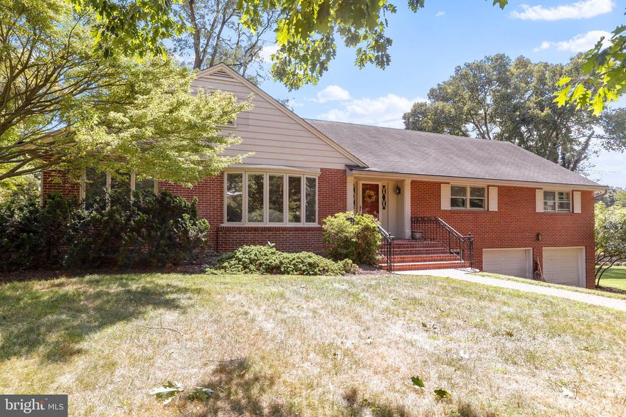 LOCATION!LOCATION!LOCATION! Spacious mostly brick Cape Code in the distinguished neighborhood of Spring Valley.  As you enter into the front hallway, it's easy to see that the house was well built with the slate entry way. Extra Large Living Room with Hardwood Floors and wood burning fireplace.  The front bay window allow for loads of light. Sun filled Formal Dining Room with Hardwood Floors.  Kitchen and Family Room with adjacent Laundry room and Half Bath. There is a screened in porch off of the main level Family Room.  All main level bedrooms are good sized with hardwood floors.  Hall Bathroom has been updated with corian countertops.  Primary bedroom does include a full bath with Shower.  The Fifth Bedroom on the Second floors actually has it's own full bath. There is a walk in attic with flooring on the Second floor.  The lower level  both finished and unfinished areas including a  2nd family room with wood burning fireplace.   Many nice plantings around the property.