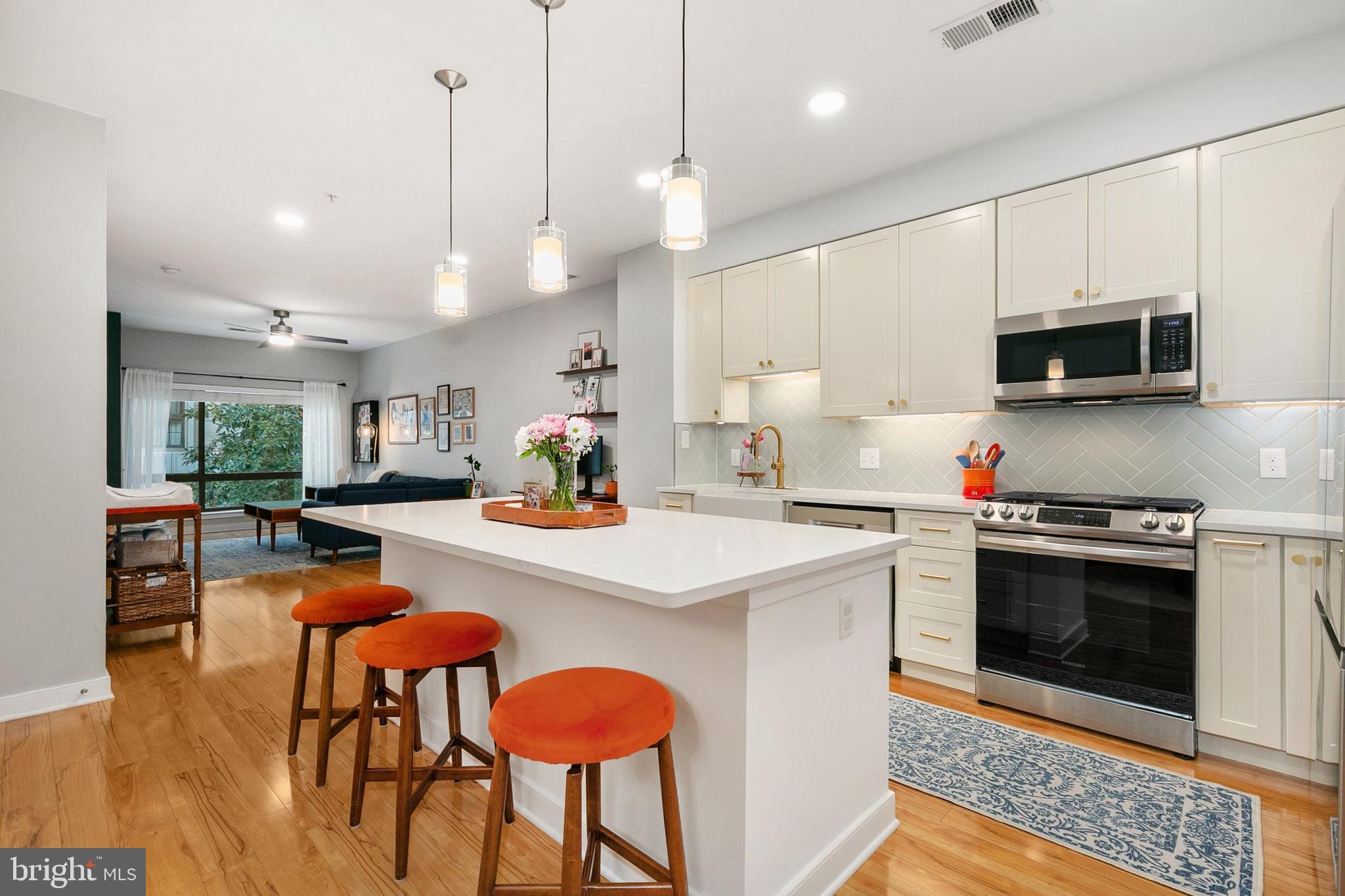 WELCOME HOME!
Impeccably kept home in the highly desirable The Orion in Downtown Silver Spring! This spacious, light-filled home boasts 9-ft ceilings, huge windows overlooking a quiet alleyway (no resident unit below), hardwood floor throughout, fresh paint. The 2023 stunning European white open kitchen features quartz countertops, a gorgeous mosaic backsplash, elegant cabinetry, and sparkling stainless appliances (2023). Recessed and pendant lighting, plus an eat-in island, are ideal for entertaining. Bright living and dining areas flow seamlessly, with a powder room for guests. The cozy den is perfect for an office or guest living space. The primary bedroom includes a large walk-in closet with custom built-in organizers and a luxurious en-suite bathroom. Convenient stacked washer and dryer. The Orion provides premium amenities: secure access, fitness center, elegant lobby, glass-enclosed rooftop lounge with fireplace and TV, outdoor grill for al fresco entertaining area with sweeping city views. Pet-friendly with bike racks and green elevators. Ultra convenient location— A short drive to Bethesda and DC, Metro within one mile, public transportation outside the building, Capital Bikeshare, and walkable distance to myriad shops, popular dining venues, AFI and IMAX theaters, Target, and more. Reserved garage parking is transferable ($150/mo). Book your private tour today, before it's too late!
