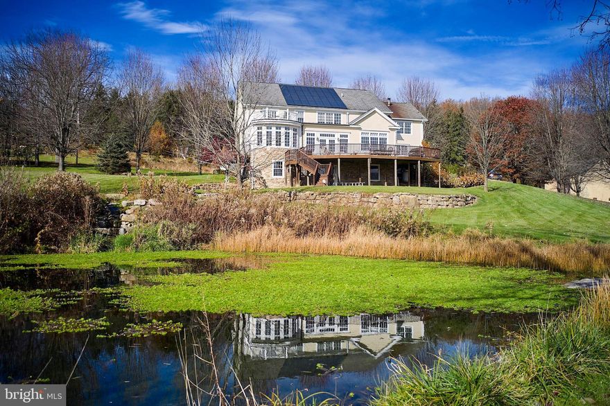 Introducing a thoughtfully crafted custom-built traditional home that seamlessly blends timeless elegance with modern comfort. Nestled on 4.5 acres in the scenic Durham valley, this residence boasts breathtaking views that will create a sense of tranquility. As you enter through the covered front porch, you are greeted by the grand 2 story foyer, leading the way through a home filled with thoughtful design and attention to detail. The gourmet kitchen with its oversized center island is the heart of the home, flanked by a formal dining room with arched entryways on one side, and the south facing breakfast room on the other side with oversized windows bathing the room with morning sun. A double-sided fireplace connects you to the sunken family room with floor to ceiling windows and custom wood built-ins offering a cozy and inviting atmosphere, making it an ideal space for both intimate gatherings and grand entertaining. Escape to the first-floor master bedroom suite, a sanctuary of relaxation with a master bath featuring a steam shower and soaking tub. This suite is complete with sunroom and private deck where you can unwind while taking in the panoramic vistas. Moving on to the second floor, there are three additional bedrooms and two full bathrooms, offering a haven for family and guests. Each bedroom is a retreat of its own...One of the bedrooms stands out with its unique feature—a rooftop terrace that beckons you to enjoy your morning coffee or stargazing into the night. A Jack and Jill bathroom connects two of the bedrooms, providing convenience and privacy. A separate home office and oversized bonus room complete the second floor offering additional flex space to use as you see fit! All levels of the home flow seamlessly with white oak random width flooring and in-floor radiant heat to keep you cozy all winter long. The full walk out lower level of the home is currently being used as a workshop, and houses a finished gym, but it also has the potential for further expansion and is roughed in for an additional bathroom, or for a potential in-law suite. But wait there's more! This eco-conscious residence features solar panels, a testament to its commitment to sustainability and energy efficiency! You will appreciate the first floor laundry room, and 3 car attached garage for all your storage needs. Out back you will find an oversized curved deck where you can sit and watch as the herons soar by the 2 spring fed ponds, and embrace in the serenity of nature, the luxury of thoughtful design, and the convenience of modern amenities this exceptional residence offers... all located in the blue ribbon Palisades School District.