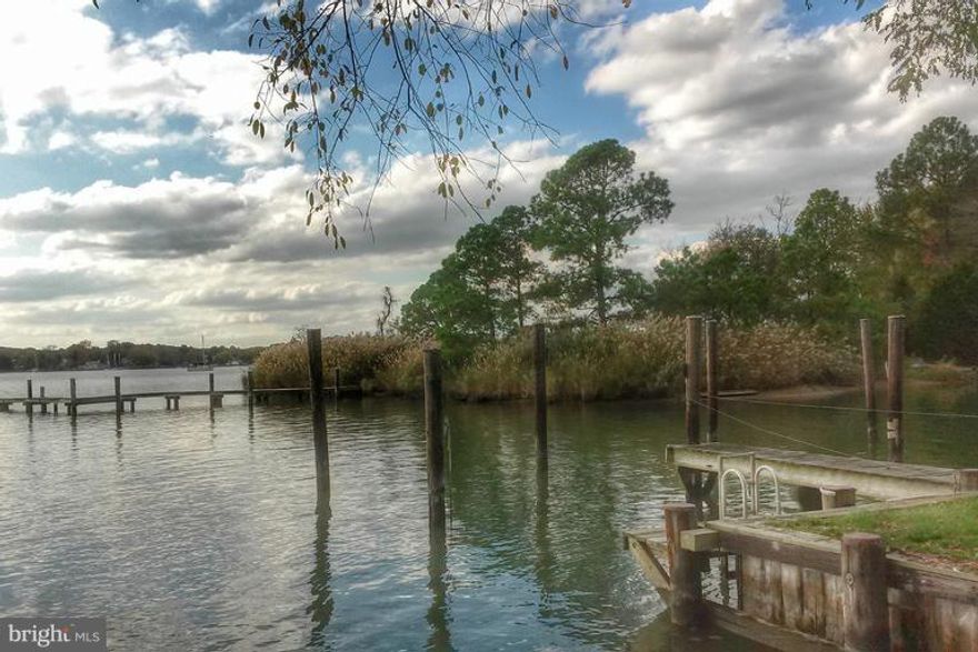 Spectacular 2+ac.level building lot with multiple bulkhead slips on protected cove on West River. Public sewer; well must be drilled. Gorgeous sunsets/nicely landscaped with assorted trees and shrubs. Property is in Scenic Rivers Land Trust/very low taxes -$371.95 (2014-15) tax record incorrect. Grading permit in progress.