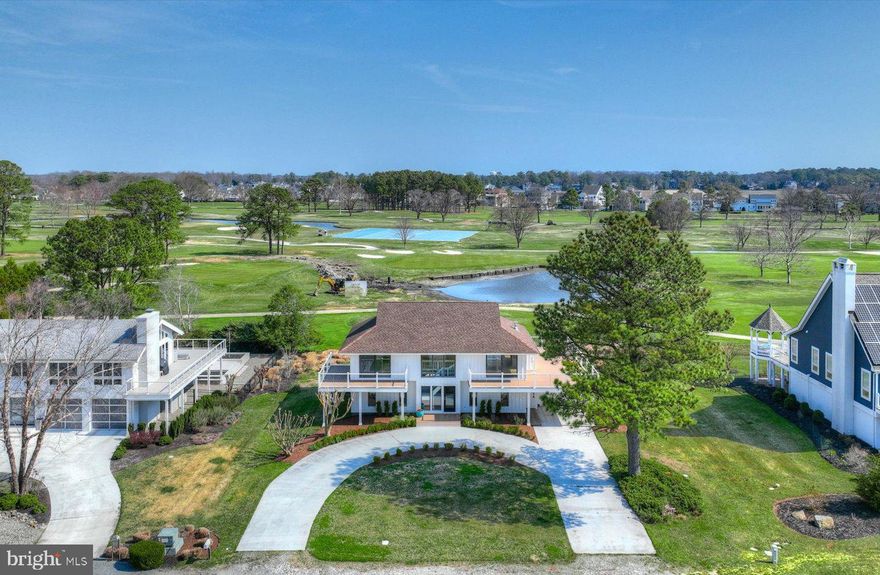 Welcome to 128 West Side Drive, ideally located in the prestigious Rehoboth Beach Yacht & Country Club. Perfectly positioned along the scenic 18th hole and just six homes from the clubhouse, this exceptional property offers sweeping panoramic views of both the golf course and Rehoboth Bay—one of the most sought-after settings in the community. This beautifully renovated coastal home features 4 bedrooms, 3.5 baths, and nearly 2,400 square feet of thoughtfully updated living space. Recent improvements include a fully redesigned kitchen and baths, new flooring, updated decks and railings, and fresh interior and exterior paint. Upon entry, a bright, welcoming foyer with an open staircase leads to the first-level living area, where a wall of glass opens to a rear deck, seamlessly blending indoor and outdoor living. This level also offers three bedrooms (or flexible office space), two full baths, and a convenient laundry room. The main living level is elevated to maximize the breathtaking views and is surrounded by expansive decking—ideal for entertaining, outdoor dining, and enjoying coastal breezes while overlooking the 18th tee. The open-concept living room is filled with natural light and features a vaulted tongue-and-groove ceiling, a shiplap gas fireplace, and glass doors that lead to the outdoor living spaces. The updated kitchen is both stylish and functional, showcasing stainless steel appliances, quartz countertops, and a breakfast bar with picturesque views of the golf course and pond. The primary suite on this level offers a peaceful retreat, complete with a beautifully tiled bath featuring a dual vanity, oversized shower, walk-in closet, and private deck access. Additional highlights include a one-car garage, outdoor shower, circular driveway, and professionally landscaped grounds. This is coastal resort-style living at its finest.