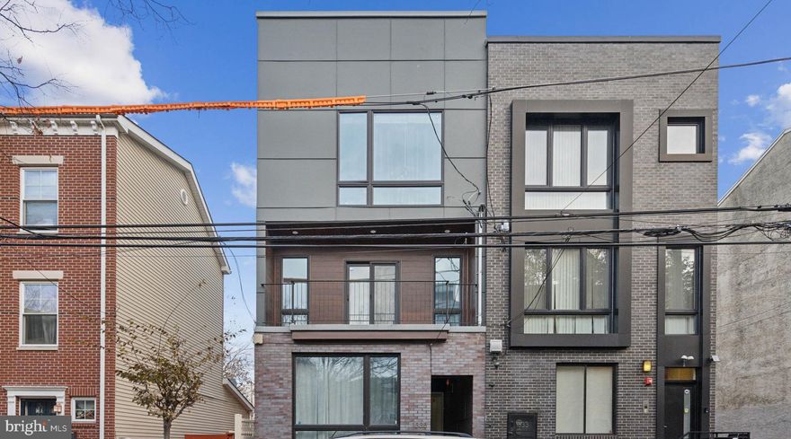 Welcome to 1335 N 7th St, a recently constructed oversized bi-level condo completed in 2019, located in the vibrant heart of Olde Kensington! This property still benefits from over 5 years remaining on the original Philadelphia tax abatement, providing significant savings for the next owner. Centrally located just north of Girard Ave and Northern Liberties and adjacent to Fishtown, this stunning condo is designed to seamlessly blend outdoor and indoor living. Unique in its large size, Unit A is a spacious bi-level home boasting a little over 2,500 sq. ft. of beautifully finished living space with two inviting outdoor areas, one on each level. As you step inside, you'll be greeted by a bright and open living space where modern design meets comfort. The large kitchen, featuring sleek finishes, flows effortlessly into a stylish dining area and a generously sized living room. From here, you can access the rear outdoor patio—perfect for enjoying your morning coffee or relaxing evenings. The main level also boasts a luxurious master suite complete with ample closet space and an ensuite bathroom for your private retreat. Heading down to the lower level, you'll find two additional bedrooms and two more full bathrooms. The rear bedroom on this level opens onto another patio, offering a peaceful outdoor escape. Located in the exciting and ever-evolving neighborhood of Olde Kensington, you’ll find yourself surrounded by some of the city’s coolest attractions. Living in Olde Kensington means immersing yourself in one of Philadelphia’s most exciting neighborhoods. Surrounded by some of the city’s best attractions, you’re just steps from trendy restaurants, boutique shops, art galleries, breweries, and cozy cafes. Walk to Northern Liberties’ Piazza, the Girard Ave El Station, or explore Fishtown’s renowned Front Street and Frankford Ave restaurant rows. For convenience, you’re close to the Sunflower Entertainment Venue, City Fitness Gym, ACME grocery store, Wine & Spirits, and so much more. Whether you’re looking for a lively evening out or a laid-back day exploring the local charm, Olde Kensington has something for everyone. This home is perfect for those who love modern style, functional design, and vibrant city living. Come see what makes this condo a true gem in one of Philadelphia’s most dynamic neighborhoods. Don’t miss the opportunity to make this exceptional property yours. Schedule your tour today!"