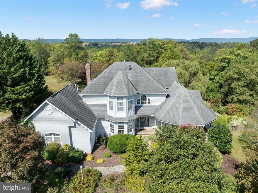 This uniquie home sits on 11.5 rolling acres and was custom built by the current owners.  With sunrise views from the primary bedroom and sunsets off the back porch, nature shines beautifully every season.  The house is filled with natural light from ample windows and the layout is thoughtful and open.  Whether you enter from the front door or the attached garage, you're met with hardwood floors and comfortable spaces.  There are 3 bedrooms upstairs with  2 full bathrooms.  The main level laundry is down the hall from the large kitchen, and a main level 4th bedroom gives you many options.  You can enjoy the outdoors from multiple decks and porches, as well as the pool-side patio.  The house is surrounded by sprawling yards that turn to forest the farther you get away from the house. The 40'x30' pole barn is large enough to park an RV, tractor, or convert to many other uses.  Part of the lot is in Forest Preservation, buyers to confirm easements and restrictions of use.