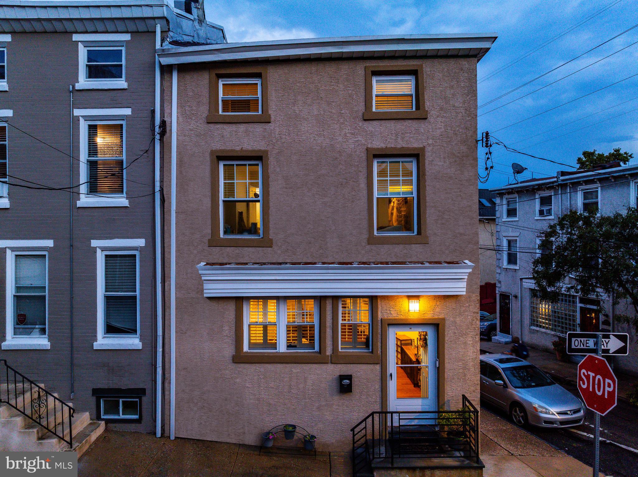 Welcome to 131 Carson Street, a spacious & updated corner home, just steps from Main Street Manayunk. This 4 bedroom, 3.5 bathroom home offers 2,160 square feet of living space across three levels. The main level features an open concept living and dining room with 10 foot ceilings, beautified by exposed wooden beams, brick, and bamboo hardwood floors. The kitchen includes granite countertops, stainless steel appliances, and a built in bar nook. Past the kitchen, you’ll find a mudroom with a stackable washer and dryer, as well as access to a half bathroom. A rear door leads to the fenced backyard, which can also be accessed through the large walkout basement. Upstairs, the large primary bedroom includes a walk in closet and an en suite bathroom with dual vanities, separate shower with a built in bench, and custom shutters. A second bedroom suite on this floor includes its own full bathroom. The 3rd floor features two additional bedrooms with sky lights and another full bathroom. Located within walking distance to Pretzel Park, the Manayunk Bridge Trail, the train station, this home offers a true Main Street lifestyle. Enjoy quick access to Fairmount Park, the Wissahickon trails, Center City, and the surrounding suburbs. Schedule your private tour and see all that this incredible Manayunk home has to offer.