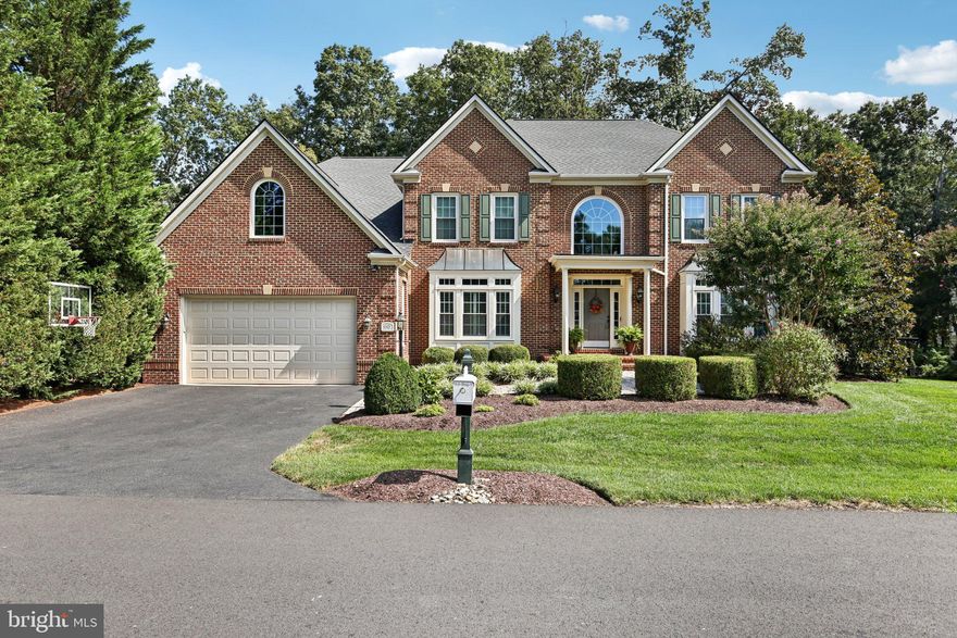 Spectacular home on a premium lot in sought-after River Creek, quietly set on a secluded street backing to trees and open common space. A grand two-story foyer with extensive moulding sets an elegant tone, and hardwoods run throughout the main level. Fresh interior paint (2024) highlights an updated kitchen with upgraded cabinetry, an oversized granite island, and newer stainless-steel appliances. The sun-filled breakfast/sunroom spans a wall of windows with serene views and opens to an expansive patio for easy indoor–outdoor living. The spacious family room features a gas fireplace and a 4' extension for added gathering space. A main-level library with a 4' extension provides a quiet work/reading space. *** Upstairs, the luxurious primary suite features vaulted ceilings, a gas fireplace, private sitting room, 4' primary bedroom extension, two walk-in closets, and a spa bath with dual vanities, soaking tub, and separate shower. A private door leads to an upper-level balcony with peaceful treetop views. Three additional large bedrooms, two full baths, and brand-new carpet (2024) complete the level.  *** The finished walk-up lower level expands the living space with a huge recreation room and wet bar (dishwasher + mini-fridge), separate media area, fifth bedroom, fourth full bath, a versatile exercise/music room, and excellent storage. An 8' extended garage with upgraded flooring and built-in cabinetry adds everyday convenience.  *** Quality features & updates: premium windows and roof (2020); HVAC systems 2013 & 2016 with whole-home humidifier and UV air purification; irrigation system with landscape up-lighting; fire suppression (sprinkler) system; plantation shutters in living & dining rooms (2025); and a newer water heater—truly move-in ready.  *** River Creek is a premier gated golf community along the Potomac River with resort-style amenities: miles of scenic trails, parks, canoe/kayak launch, fitness center, pools, clubhouse with river views, and tennis/pickleball; optional golf memberships available. Convenient Loudoun location near shopping, dining, wineries, historic towns, and major routes: Rt 7, Rt 28, Dulles Toll Rd/Greenway, Dulles International Airport, Ashburn Metro, One Loudoun, Village at Leesburg, and Historic Downtown Leesburg.