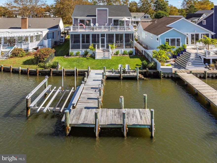 Welcome to your private waterfront paradise. This stunning bayfront home offers wide-open southerly views and direct access to the water from your own private pier — complete with boat slip and jet ski lifts. Whether you’re entertaining on the spacious deck, enjoying morning coffee with the sunrise, or cruising out for a sunset ride, this home captures the essence of relaxed luxury living on the bay. Designed for coastal living, this residence features open and bright living spaces with large windows framing stunning bay vistas. Stepping inside your dream home — where comfort meets style. This 4-bedroom, 3-bath retreat offers an inviting open floor plan, perfect for gatherings and cozy nights entertaining or relaxing while taking in breathtaking sunsets.. The kitchen features stainless steel appliances, a dry bar with beverage refrigerator, a large white farmhouse sink, abundant counter space, and windows framing the bay. The open living room centers around a stone fireplace flanked by sliders showcasing stunning water views. The bay front primary suite includes a full bath and a private screened porch — the perfect place to unwind and take in the sunsets. Enjoy expansive outdoor spaces provide the perfect setting for entertaining or relaxing while taking in breathtaking sunsets — a rare opportunity for luxury bay front living. Interior photos will be uploaded Friday.
Showings will begin Saturday  10/18 Public Open House October 18 10:00-1:00