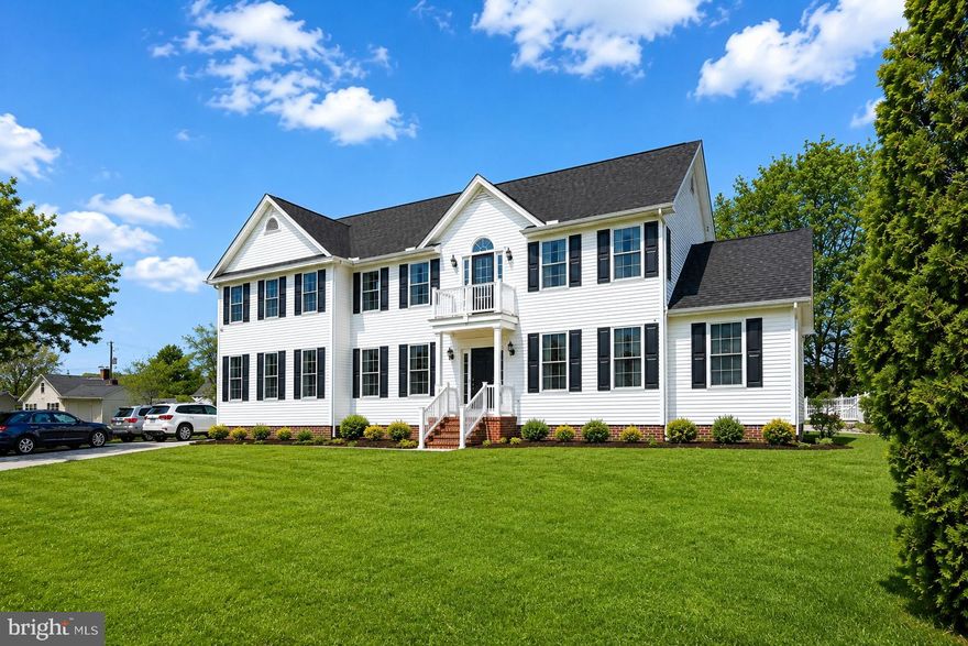 **OWNER FINANCING AVAILABLE**  Welcome to this expansive custom-built Colonial by Piney Island Builders, offering over 4,400 square feet of living space on a private 0.75-acre lot in the heart of downtown Berlin, Maryland. Combining size, flexibility, and an unbeatable location, this 8-bedroom home is ideal for multi-generational living, remote work, vacation living, or anyone seeking a spacious Eastern Shore retreat just minutes from Ocean City beaches. The main level showcases a dramatic two-story great room with soaring ceilings, oversized windows, a gas fireplace, and an open staircase with loft views that fills the home with natural light. Formal living and dining rooms are connected through elegant arched openings, creating a seamless layout for entertaining. The spacious open-concept kitchen overlooks the breakfast area and family room, making it the true center of the home. A standout feature is the highly desirable first-floor layout offering three bedrooms and a full bathroom, providing exceptional flexibility for guest suites, home offices, fitness space, or convenient main-level living. Upstairs, you’ll find five additional bedrooms and two full bathrooms, including a generously sized primary suite with a soaking tub, separate shower, and abundant closet and storage space. The fully finished lower level provides expansive recreation and entertainment space perfect for a media room, game room, home gym, or additional living area. Additional features include public water and sewer, propane heat with underground tank, central HVAC, electric water heater, resurfaced driveway, two storage sheds, and a new refrigerator. The adjacent lot next door is also available, creating a rare opportunity for additional privacy, expansion, or investment potential. Located in one of Maryland’s most desirable small towns, this property is minutes from downtown Berlin’s award-winning shops, restaurants, parks, and schools, while offering convenient access to Ocean City beaches, Assateague Island, golf courses, marinas, boating, and everything the Maryland Eastern Shore lifestyle has to offer. If you’ve been searching for a large home in Berlin, MD with acreage, flexible living space, and proximity to Ocean City, this property offers exceptional value and endless possibilities.