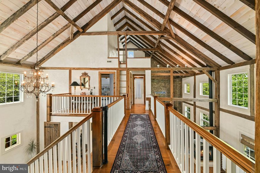 This amazing property is just steps away from the renowned Saucon Valley Country Club. Welcome to marvelous architectural features at every turn. This Saucon Valley home’s extraordinary character evolved from a legacy barn restored into a unique residence that boasts the best of old and new … combining space, light and imagination.
Inside, warm wood flooring, custom doors and cabinetry, exposed posts and beams, cathedral ceilings and stunning window placement set the mood for a perfect retreat that redefines the meaning of barn conversion. The main floor is boldly open and yet delivers an intimate warmth with a fabulous, white, gourmet kitchen. The flow between the spacious rooms is inviting and free. A first floor master bedroom suite, with fabulous bath, is a romantic oasis. Two additional 2nd floor bedrooms and an office are distinctive, with vaulted, beamed ceilings and dramatic window placements. Finally, the expansive
lower level provides a family room, guest room and full bath and doors to the outside in every room.
A covered deck and covered patio with fireplace are surrounded by magnificent gardens that bloom all year round. This magically private property is just minutes from the Promenade shops, convenient to I-78 and under 90 minutes to NYC. Relax amidst your beautiful gardens or play a round of golf and dine at the world class Saucon Valley Country Club.