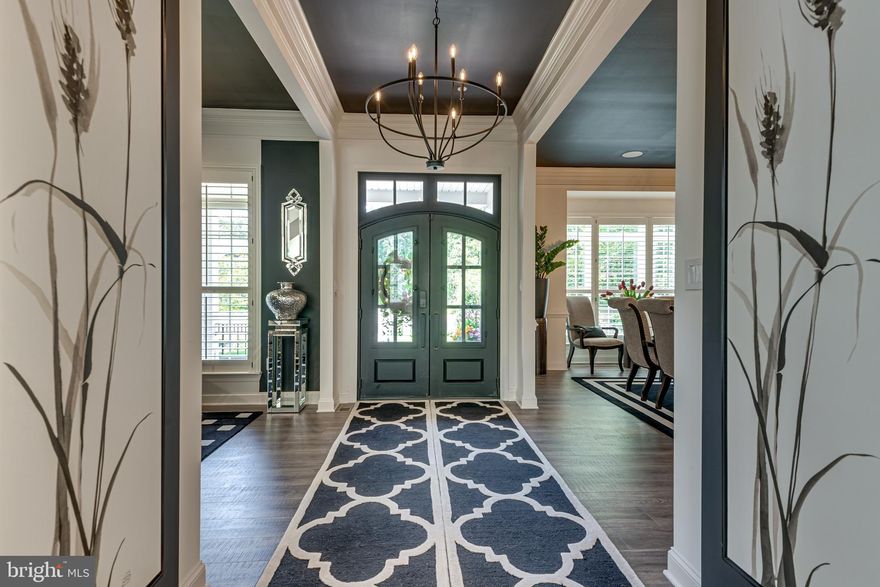 Sophisticated Luxury.   Arrive at Severn Highlands, an exclusive gated community of only  8 homes, all on large lots.  Enter your circular private  driveway and proceed back to decide to park in the attached 2 car garage or the  attached 2 car tandem garage.  Walk along the winding front walkway to the front double doors and covered front porch.  Enter into the elegant foyer with views directly into the two story great room.  Ten foot ceilings throughout the rest of the main level which include an elegantly appointed formal dining room, a living room and grand kitchen  area that includes pantry, kitchen table space and an out door deck overlooking the extensive patio area below. If you enter from the garage, there is a second foyer and closets along with half bath with a short hallway leading to the kitchen area.  Generously sized main level bath with walk in closet and ensuite bath completes the main level floor plan Alighting on the staircase,  arriving on the upper level, there are three additional bedrooms, two share a buddy full bath there is a laundry room and the Primary Suite is accessed through a double door entry, spacious bedroom with sitting area, bar area with beverage cooler and elegant glass front cabinetry leads back to an elegantly appointed ensuite bath with soaking tub, oversized shower, commode room and super sized vanity counter with dual sinks.  The walk in closet has custom designed clothes and shoe spaces.  As you descend the lower level staircase you enter into a custom built entertainment and recreation area with classic designs.  There is a classic club room media area with a built in wet bar with refrigeration, a  fifth bedroom with attached  full bath, home gym area, home office area with separate entrance, mechanical area and three storage closets.   This level walks out to the patio area which includes a covered patio area, open patio stretching all across the back of the home with outdoor gas lighting and multiple entertaining areas with access back up to the main level via stairs to the deck.  The back yard is surrounded by 200 acres of wooded conservation area.  Owner has a pool permit ready for construction in 2024.  Customization and upgraded fixtures adorn this lovely home throughout including the ability to install an elevator, the shaft exists in the home, contact agent for details.   Excellent location for access to all major roadways and airport with the feeling of pastural privacy.  

Furnishings can be purchased.

See documents for list of features and upgrades.  Click on the paper icon for the documents and downloadable/printable floor planlease view video of the home and property with drone footage by clicking on the camera icon.