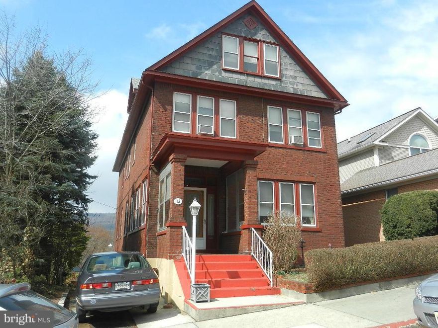 Stately brick residence just off Washington St. and conveniently located near county library and Court House.  Dwelling features 5 bedrooms, 4 full baths, two kitchens, full basement, garage and ample off-street parking.