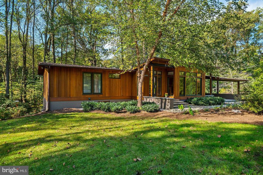 AWARD-WINNING, AUTHENTIC CONTEMPORARY DESIGN in a perfect location! Just minutes to DC, this IMMACULATE like-new home is nestled in the trees & offers an OPEN PLAN w/Gourmet Eat-in KITCH, Butler's Pantry, Hardwoods & Main LVL Master Suite. Lower Level boasts custom built-ins, WET BAR,& full daylight w/ walk-out Atrium to Stone Patio, stor & rear OASIS plus En-Suite BedRM w/Attach BA & Dressing RM!