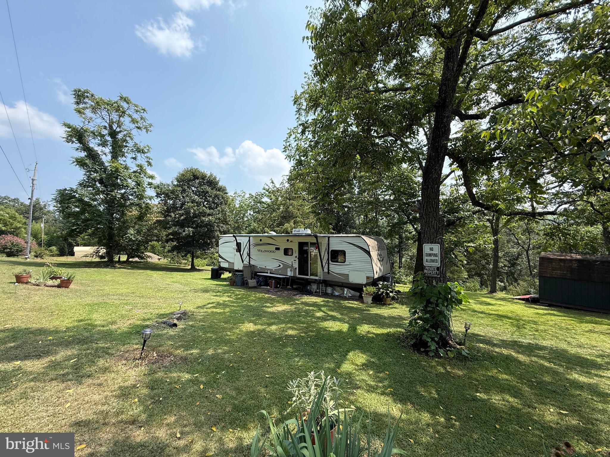This 2.185 AC lot is perc'd and ready for a 3BD/2BA dream home built to a new owner's taste! Currently Seller has a 2014 RV (RV is a 2014 Forest River Wildwood Model 37BHSS2Q) with bump-out set up on lot with electricity and everything you would need to make this your get away from the hustle and bustle of the city - Seller has water hauled in and sewage haul away set up costing under $300 a month. Current wifi is with Star Link and works perfectly(equipment does not convey)! There is a seasonal stream on property and hunting is allowed. Only 15 minutes to 3 different public accesses to the South Branch River for fishing, boating, swimming and floating! Visit nearby local farmers market and food trucks only 10 minutes from property! The town of Romney is a short 30 min drive. Make an appointment today to see this lovely piece of West Virginia!