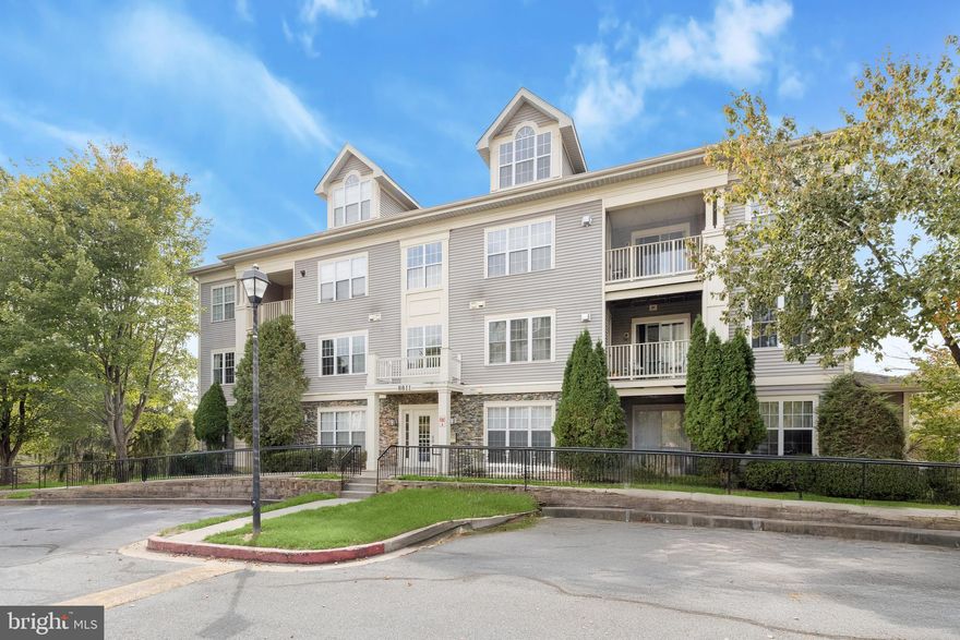 Three bedrooms and two full bathrooms await in this spacious second-floor condo in Stone Ridge, offering over 1,200 square feet of comfortable living space. A neutral color palette and plush carpeting create a welcoming atmosphere, complemented by modern luxury vinyl plank flooring in the kitchen and bathrooms. The kitchen showcases stainless steel appliances and quartz countertops, with a separate dining area for enjoying meals. A gas fireplace anchors the living room and sliding glass doors open to the private balcony for relaxing outside. The primary bedroom features two closets, including a walk-in, along with an ensuite bathroom with a tub shower. Two additional bedrooms share a connecting full bathroom with a glass-enclosed walk-in shower, and a dedicated laundry room adds convenience with extra storage.
