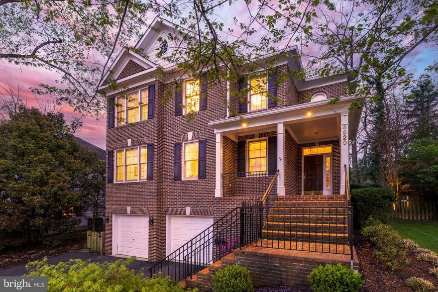 Welcome to 4520 Dittmar Road, an exquisite all-brick colonial nestled in Arlington's prestigious Country Club Hills community. This distinguished residence, built in 2001, offers six bedrooms and 4.5 baths across three meticulously finished levels. As you enter the grand two-story foyer, you're greeted by soaring ceilings and elegant crown molding. The main level boasts formal living and dining rooms, a private office, and a gourmet kitchen equipped with a spacious island, cooktop, dual wall ovens, and maple cabinetry. Adjacent to the kitchen, the expansive family room features built-in bookcases and a cozy gas fireplace, leading seamlessly to a beautifully landscaped backyard with a paver patio—ideal for outdoor gatherings. The upper level is highlighted by a luxurious master suite with a tray ceiling, dual walk-in closets, and a spa-like bath complete with a soaking tub, separate seamless glass shower, dual vanities with granite countertops, and a private toilet room. Additional bedrooms include a generous en-suite and two sizable rooms sharing a dual-vanity bath; a conveniently located upper-level laundry room adds practicality. The lower level offers a mudroom with built-ins for organization, two versatile bedrooms, a full bath, and a spacious recreation room. Situated on a private homesite, this property is just four blocks from the esteemed Washington Golf & Country Club at 3017 N Glebe Rd. The Country Club Hills neighborhood is renowned for its lush landscapes, spacious estates, and a strong sense of community, hosting events like block parties and an annual Fourth of July parade. Residents enjoy proximity to top-rated schools, upscale shopping, fine dining, and scenic parks. Commuters will appreciate the convenience of being approximately 3 miles from the Ballston Metro station and a short drive to Ronald Reagan Washington National Airport (DCA), facilitating effortless travel. This home seamlessly blends elegance, comfort, and an enviable location—truly a rare find in Arlington's real estate market.