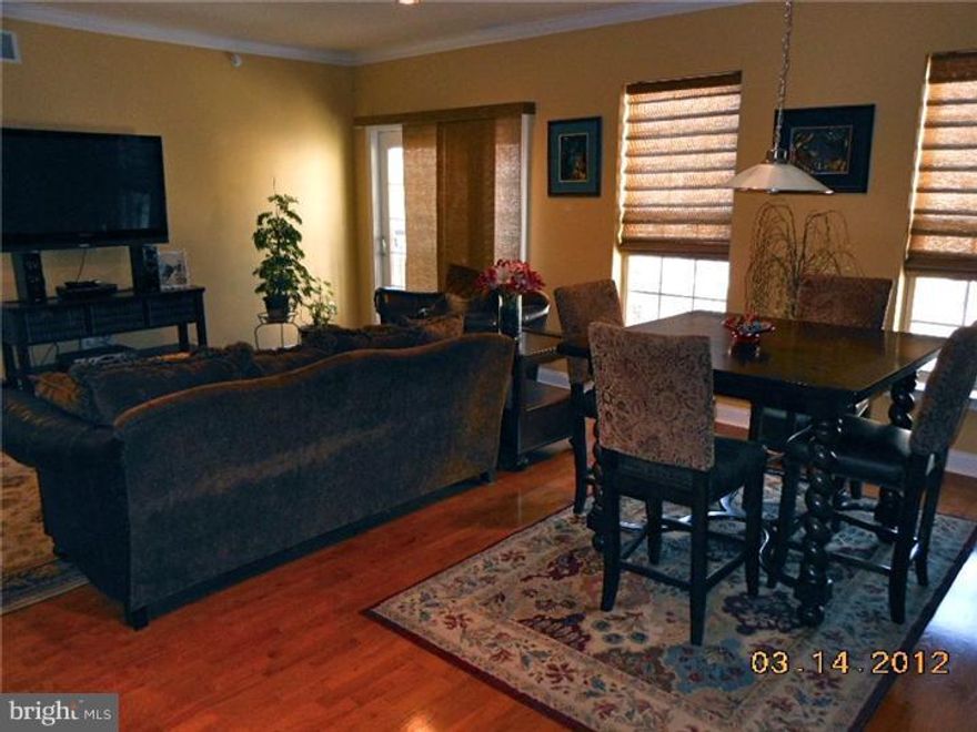 This lovely 2 Bedroom 2 Bath condo w/PARKING leaves nothing to be desired. Chef's kitchen with stainless appliances, island, and breakfast bar overlook an expansive open floor plan. Hardwood floors, recessed lighting, granite counters, and custom tile are only a few of the many beautiful upgrades. Home includes custom lighting fixtures and window treatments throughout. The master bedroom suite boasts a luxurious bath with soaking tub, separate shower, and walk-in closet. A large second bedroom, additional full bath, and laundry with full size washer/dryer complete this amazing residence. Prime location in Naval Square, Toll Brothers beautifully landscaped, gated community, offers walking distance from CC business district and UPENN. Community amenities include concierge, outdoor pool and sundeck, fitness center, This home is a must see!