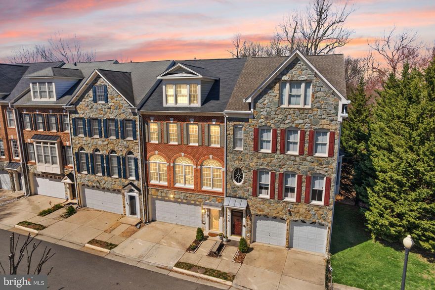 Welcome to this exceptional four-level, 4-bedroom, 3.5-bath home tucked away in a private setting, yet perfectly located in the heart of Fairfax. This stunning residence is filled with natural light, highlighted by dramatic floor-to-ceiling windows, tall ceilings, gleaming hardwood floors, and meticulous attention to detail throughout.

From designer custom paint to updated flooring and modern lighting, no detail has been overlooked. The Tuscan-inspired main level features soaring 9+ foot ceilings, a spacious living room with stunning arched transom windows, formal dining area, and a gourmet kitchen that seamlessly flows to a private deck with premium scenic views of the community green space and wooded area—perfect for relaxing, grilling, or entertaining.

The first upper level offers three generously sized bedrooms, one with its own ensuite bathroom plus two additional full baths, and a convenient laundry room. The top level is dedicated to a truly special and expansive primary retreat, complete with multiple walk-in closets, a large sitting area and a beautifully appointed ensuite bath.

The lower level doesn't feel lower at all, thanks to its surprisingly high 13' ceilings and tall transom windows. A spacious rec room with a cozy gas fireplace walks out back to a second deck with gated access to the beautiful community green space. Go explore...Spring has sprung!

Enjoy all the amenities this sought-after community has to offer, while being right across the street from Wegman's, and just moments from premier dining, shopping, and entertainment in Fairfax Corner, and beyond!

With two newer furnaces, two newer AC's (2023), a newer water heater, and a roof under 10 years old, you'll have peace of mind and comfortable living for years to come. And don't miss the extra garage storage! 

This is the one you’ve been waiting for—don’t miss it! Schedule your private tour today, or stop by the wine & cheese open house Friday 4-6 or the Sunday open house from 2-4pm.