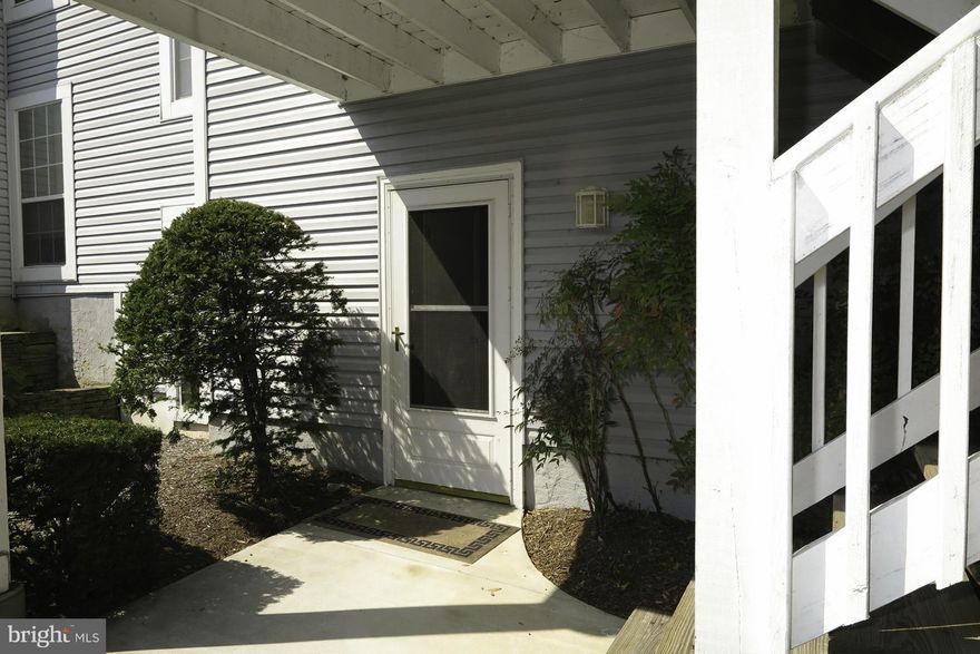 Superb large square footage ground level unit nestled in sub-division with secluded parking. Patio with railing off sun room, bonus den/office behind wood burning fireplace! Newer carpet, VESA TV mounts in LR + MBR convey, pre-wired for speakers. Kitchen has pass-thru to dining room. Sun room has ceiling fan w/light kit. Close to shopping and schools, great location, great price. See View Docs