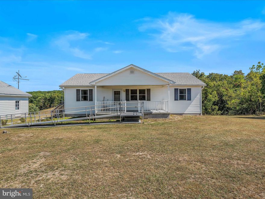 651 Johnson Mill Road Berkeley Springs, West Virginia offers 3.09 Unrestricted acres with Barn, Corn Crib, 2 Car over sized Detached Garage, 2 Bedrooms - Primary Bedroom features handicapped shower. More features - Office/Den , Great Room and separate Mud room/Laundry room, full walk out basement with roughed in plumbing for bath.  Minutes from downtown Berkeley Springs and County amenities. NEW PRICE - $367,000. Call for your private showing soon.