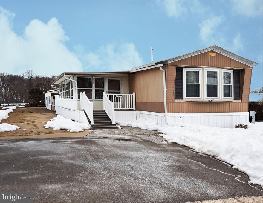 Well-maintained single-level home in Eastern Dawn Mobile Park offering 2 bedrooms and 2 full bathrooms. The open living area provides a comfortable flow with abundant natural light, while wood beams and built-ins add both character and functional storage. The spacious sunroom offers additional living space, perfect for relaxing or hobbies. Central A/C and ceiling fans support year-round comfort. Exterior features include a two-car driveway and a storage shed for additional space. Low-maintenance living in a quiet community setting.  HOA covers Common Area Maintenance, Security Gate, Sewer, Snow Removal, Trash and Water.
The community requires a minimum 670 credit score pulled from TransUnion and does not allow dogs. All potential buyers must submit and offer and then apply through the park office. The real estate agent, broker, and seller do not have any influence or control over the application process.