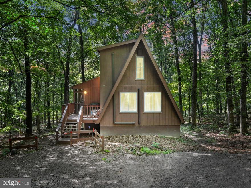 Charming Mountain Retreat in Coolfont Mountainside- Whether you're seeking a weekend getaway, investment property, or full-time residence, this home is a proven Airbnb income generator. 
Nestled in the serene, wooded setting of the private Coolfont community, this contemporary 3BR/2BA home is the perfect blend of comfort, style, and natural beauty. The main level features an open-concept living and dining area with a cozy woodstove, an updated kitchen with stainless steel appliances, and a spacious primary bedroom with a full bath.
Upstairs, you’ll find two additional bedrooms, a full bathroom, and extra storage space. The finished lower level offers a large game room, bonus room (currently used as a 4th bedroom), utility room, and walk-out access to a private hot tub—ideal for relaxing after a day of exploring.
Step into the screened-in porch and unwind while enjoying the peaceful sights and sounds of nature.
Coolfont offers a relaxed mountain lifestyle with access to community amenities including an outdoor pool, tennis courts, playground, hiking trails, and a recreation barn. Just minutes from the swim and fitness center featuring a heated saltwater pool, and a short drive to historic downtown Berkeley Springs for shopping, dining, and weekend events.
Whether you're seeking a weekend getaway, investment property, or full-time residence, this home is a proven Airbnb income generator. Live the lifestyle.